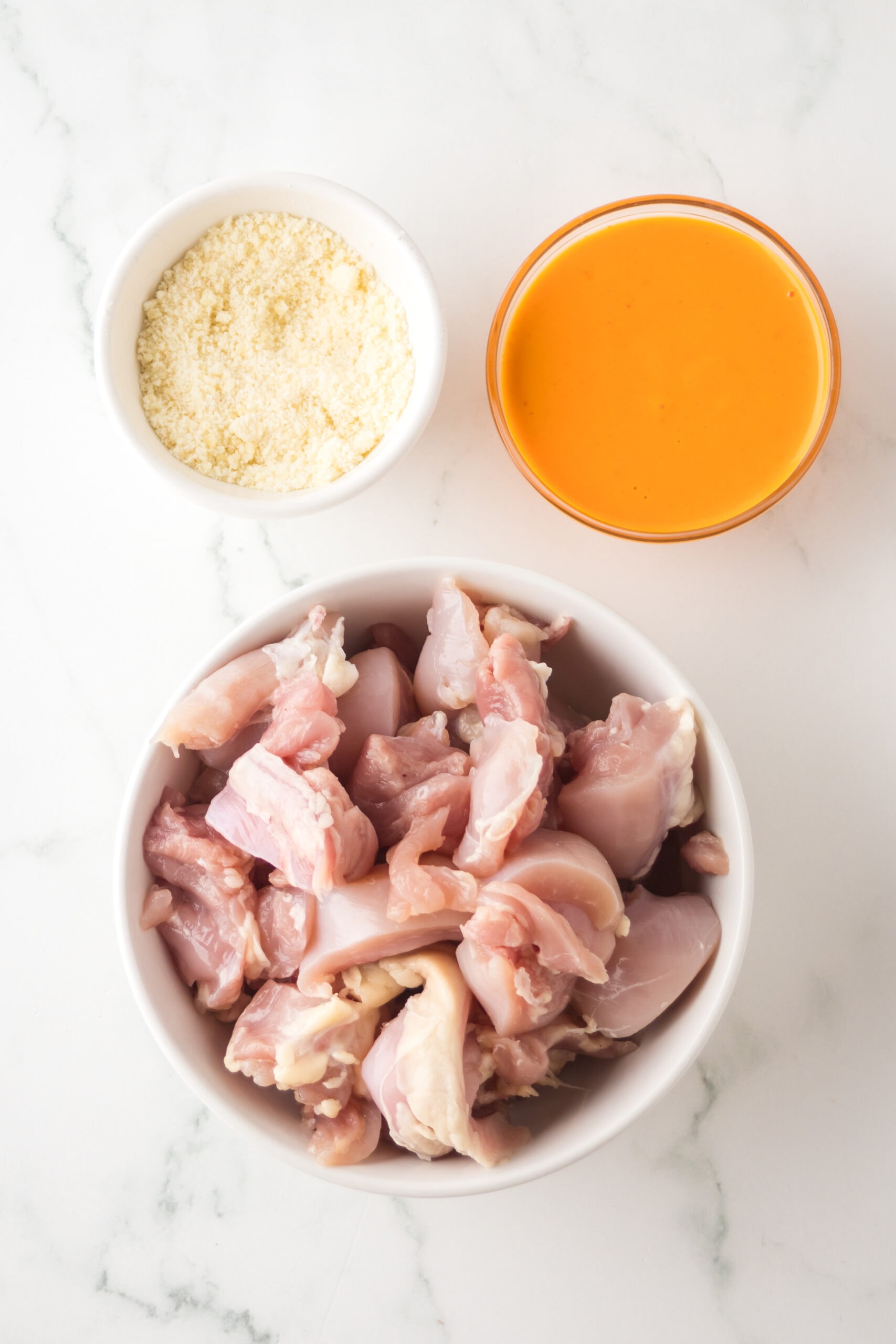 All ingredients pictured: chicken thighs, parmesan cheese and buffalo sauce