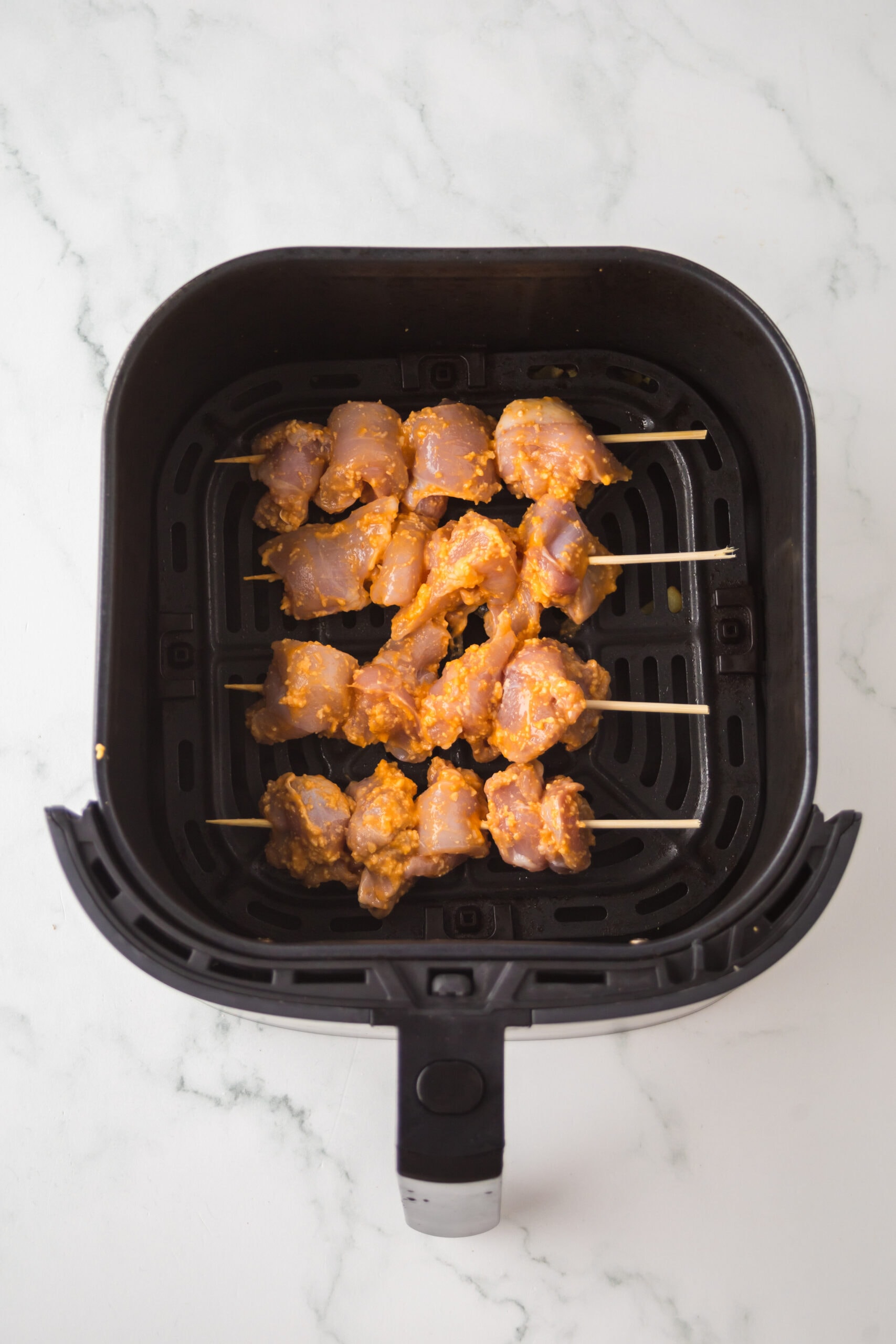 Place buffalo chicken thighs in air fryer, some space apart