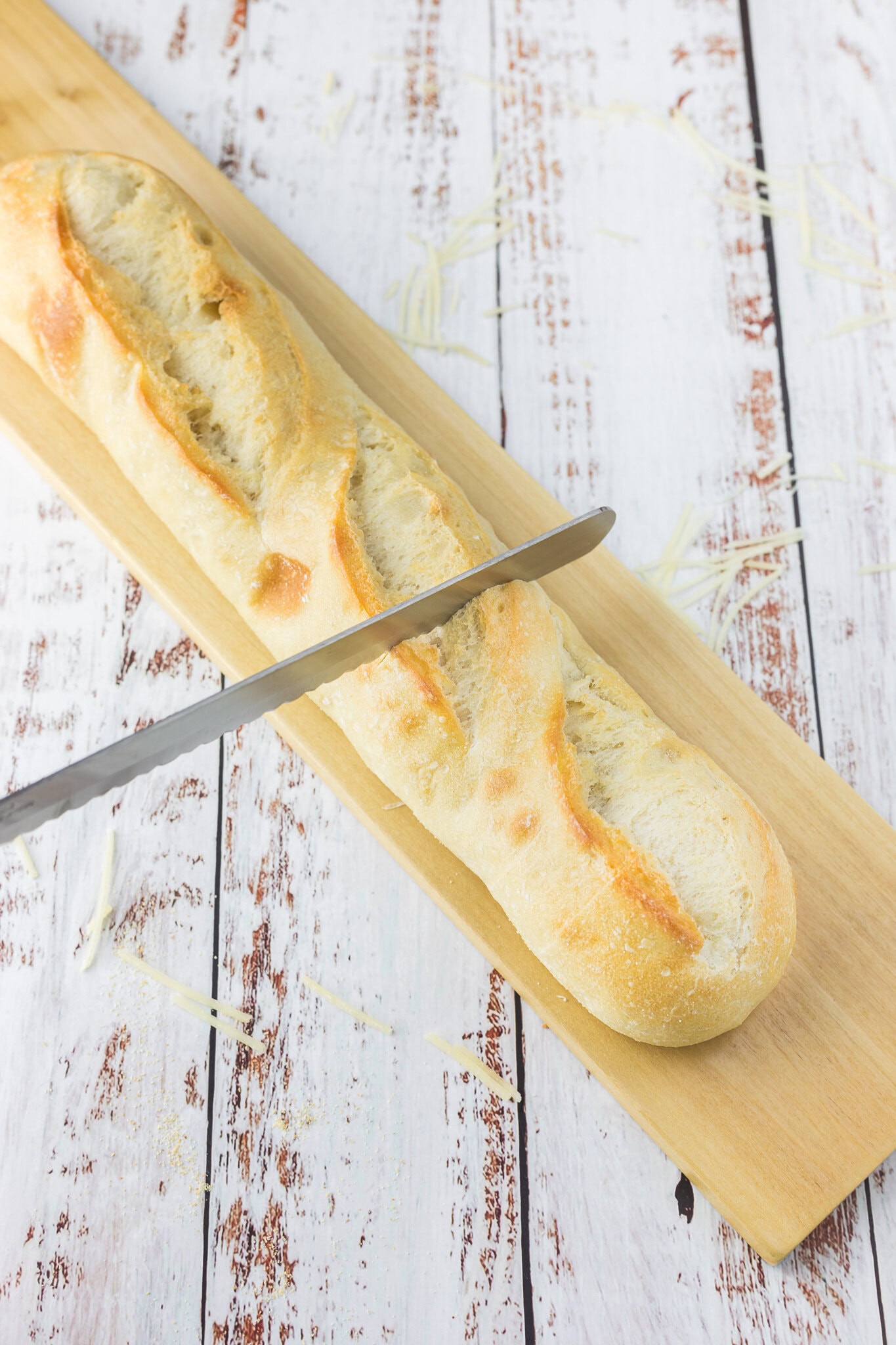 Cutting the french bread to add the butter mixture