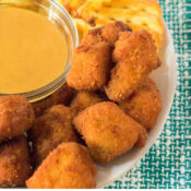 Chick Fil A sauce all made up in a bowl, and on a plate is Chick Fil A nuggets and waffle fries, a tea towel under the plate