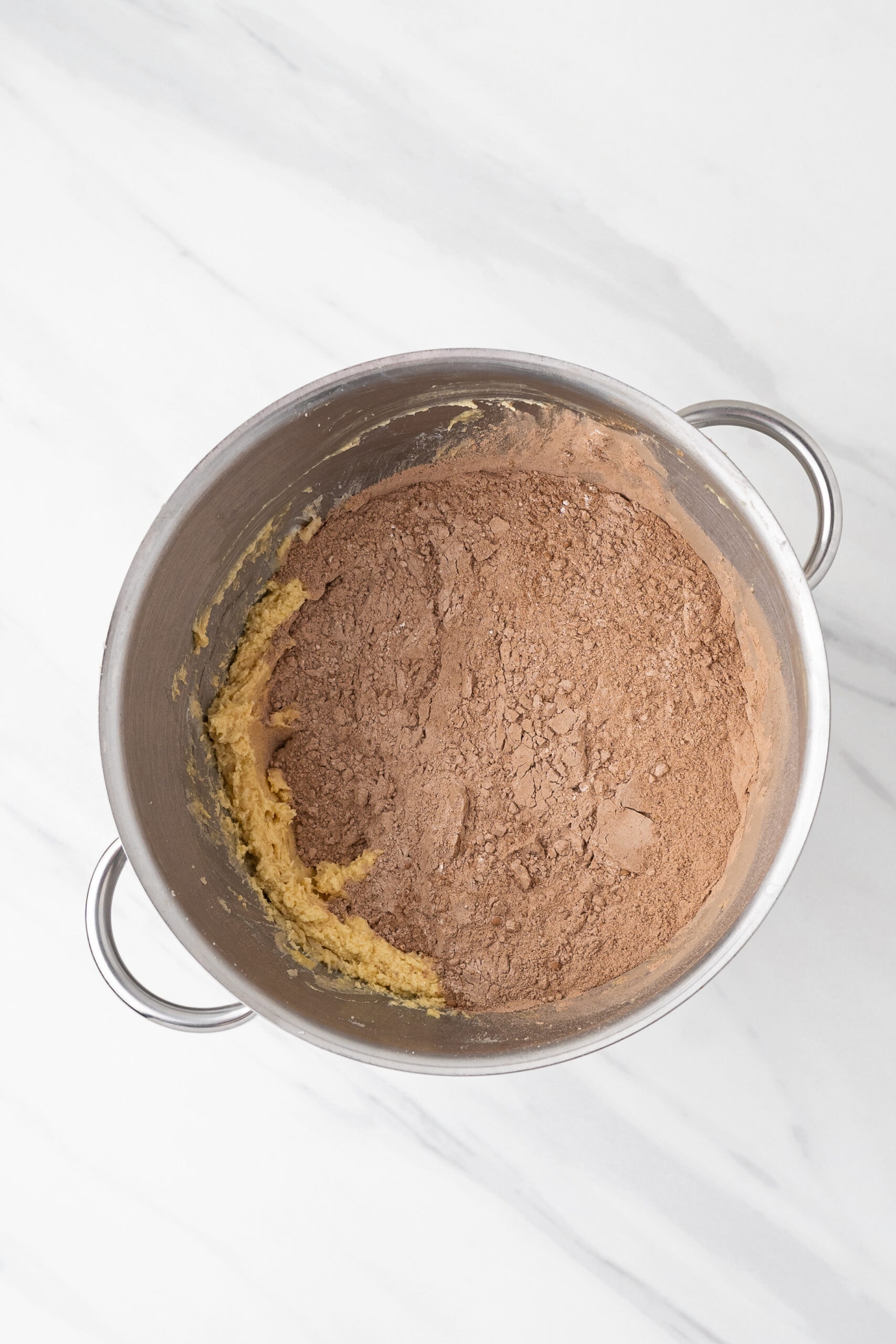 Adding cocoa to the egg mixture to create the cookie base