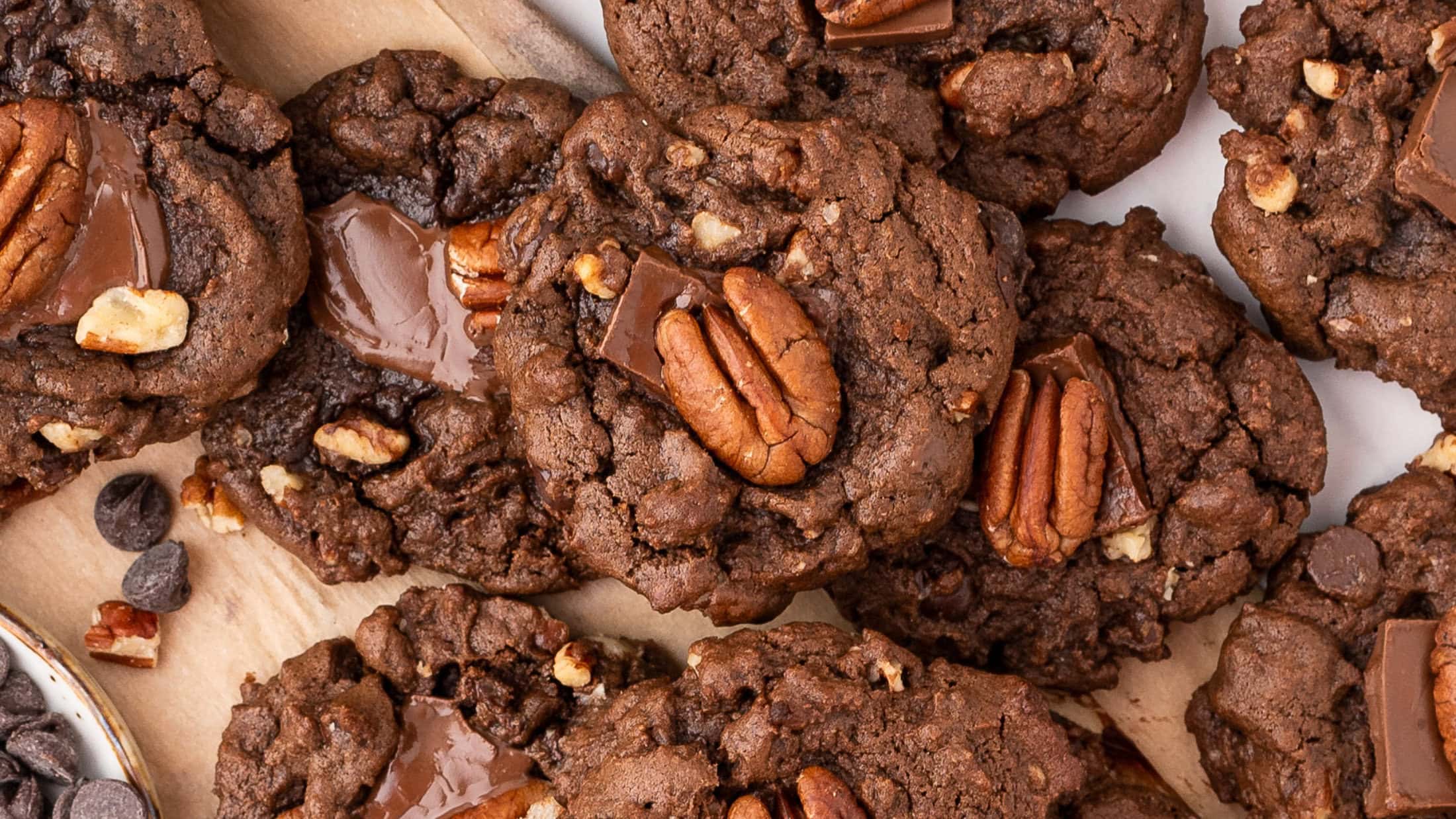 Chewy double chocolate pecan cookies all baked and stacked up