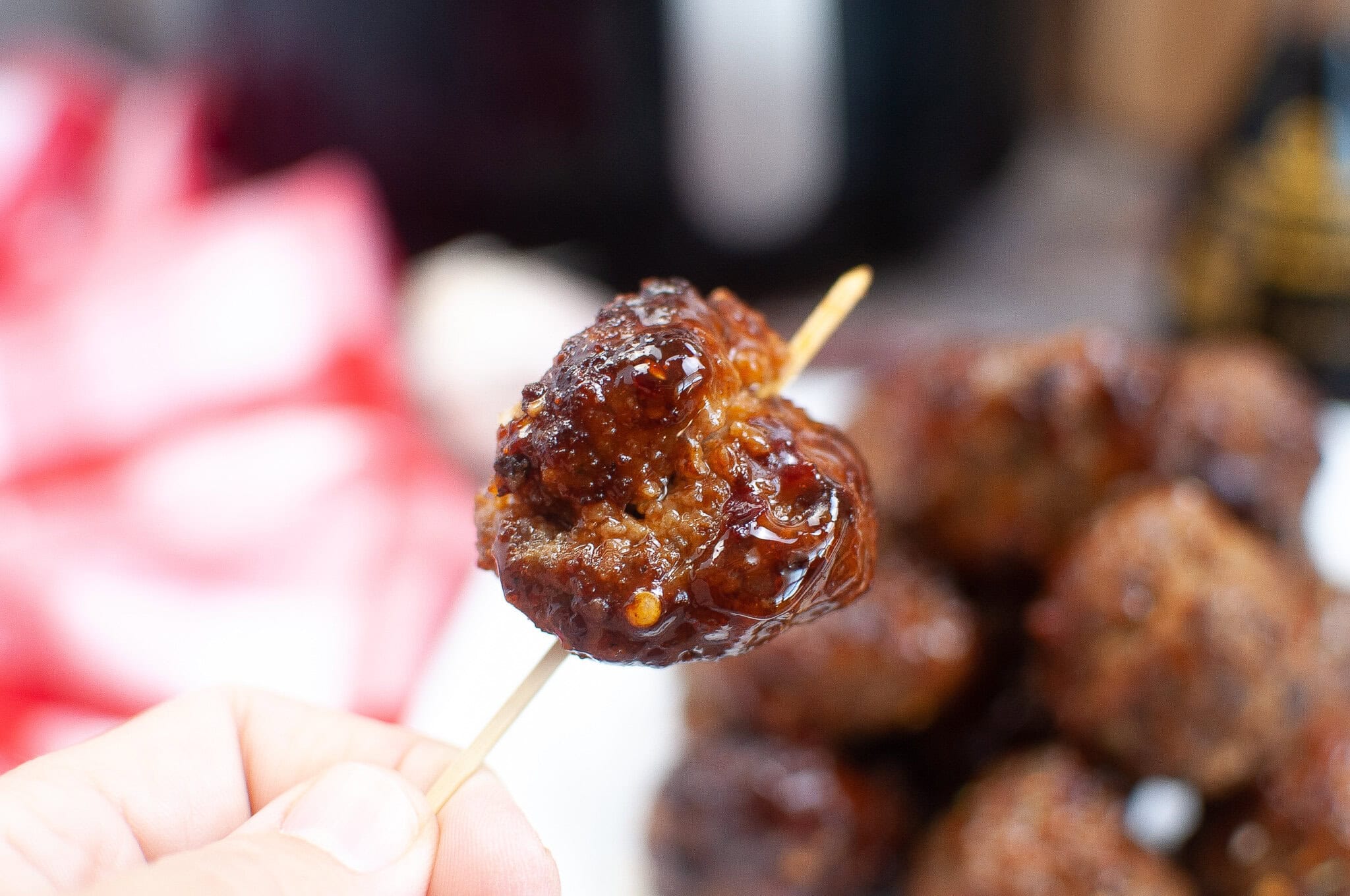 An air fryer meatball on a toothpick, close up