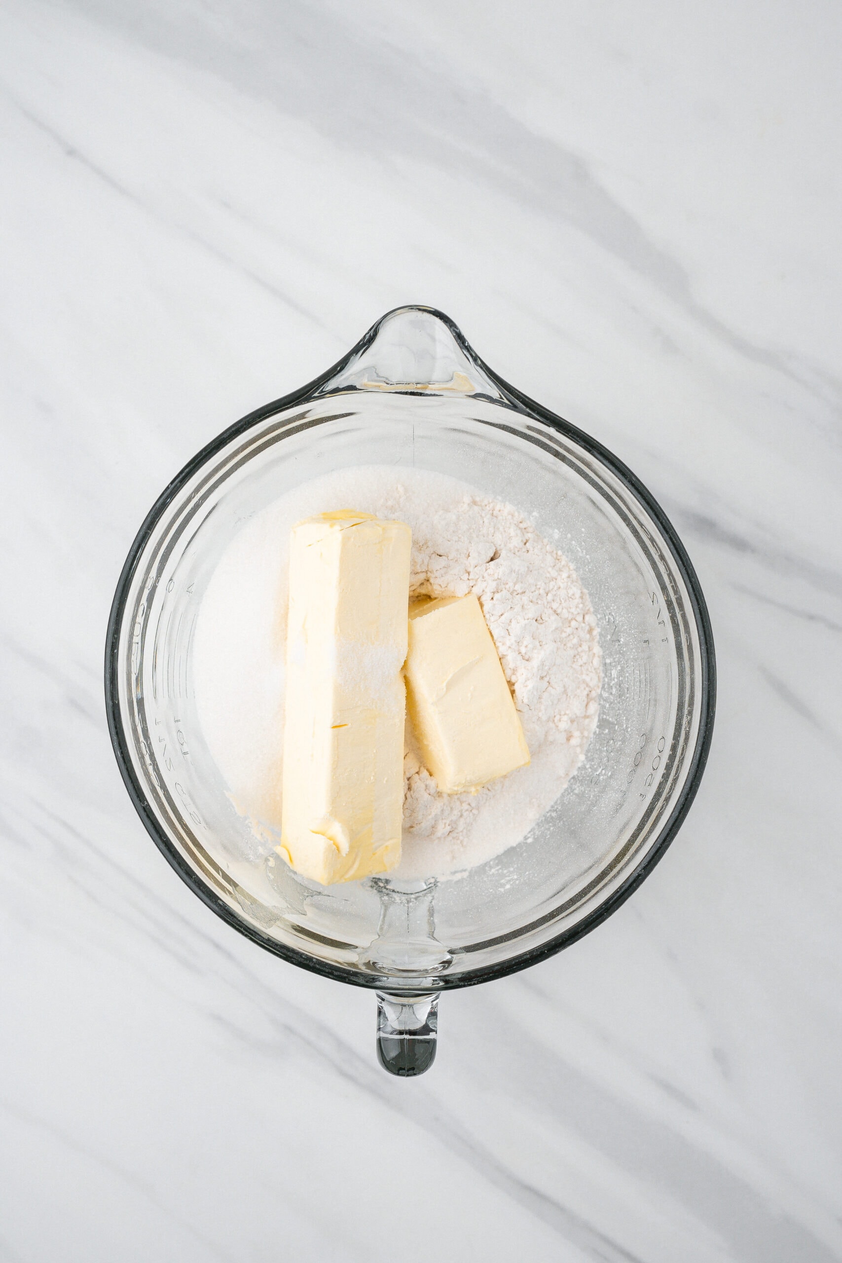 Softened butter in a bowl, added to the top of flour