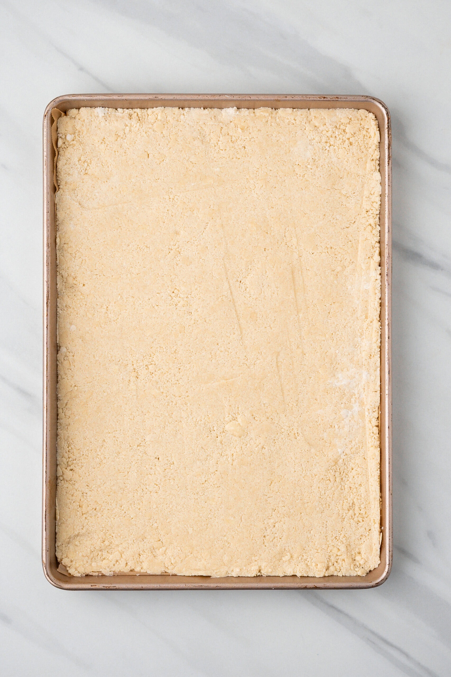 Shortbread crust in the baking pan.
