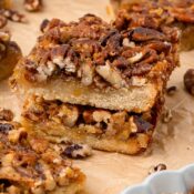 Close up stack of two easy pecan pie bars. Showing the texture of the shortbread.