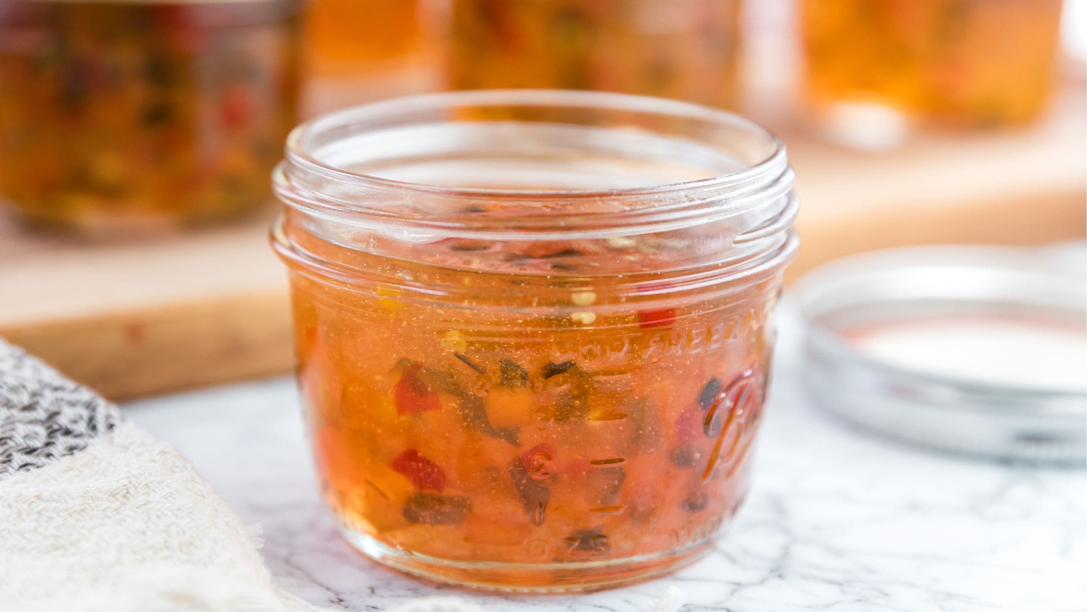 Hot pepper jelly in a glass jar, ready to be enjoyed