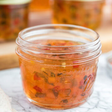 Hot pepper jelly in a glass jar, ready to be enjoyed