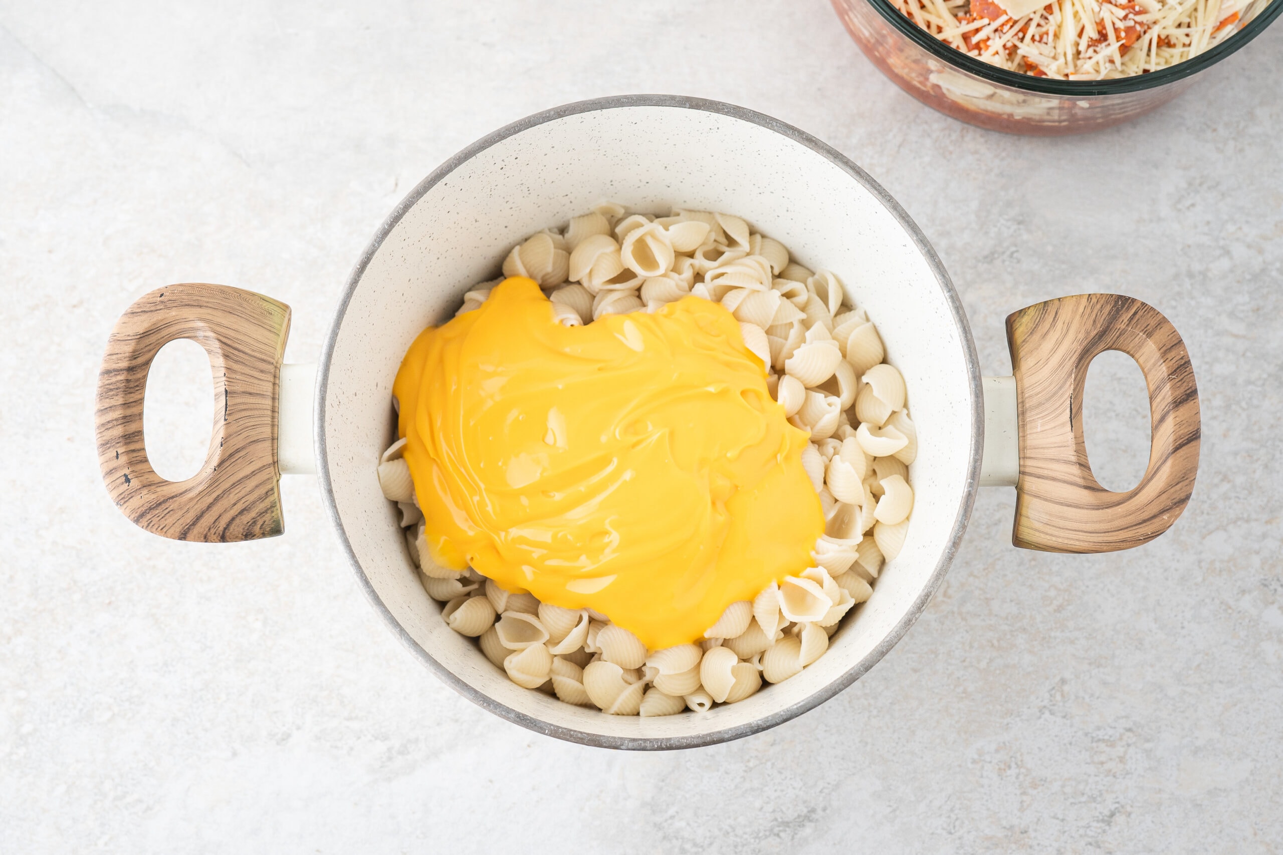 Adding Velvetta cheese pouch to finished pasta shells in sauce pot