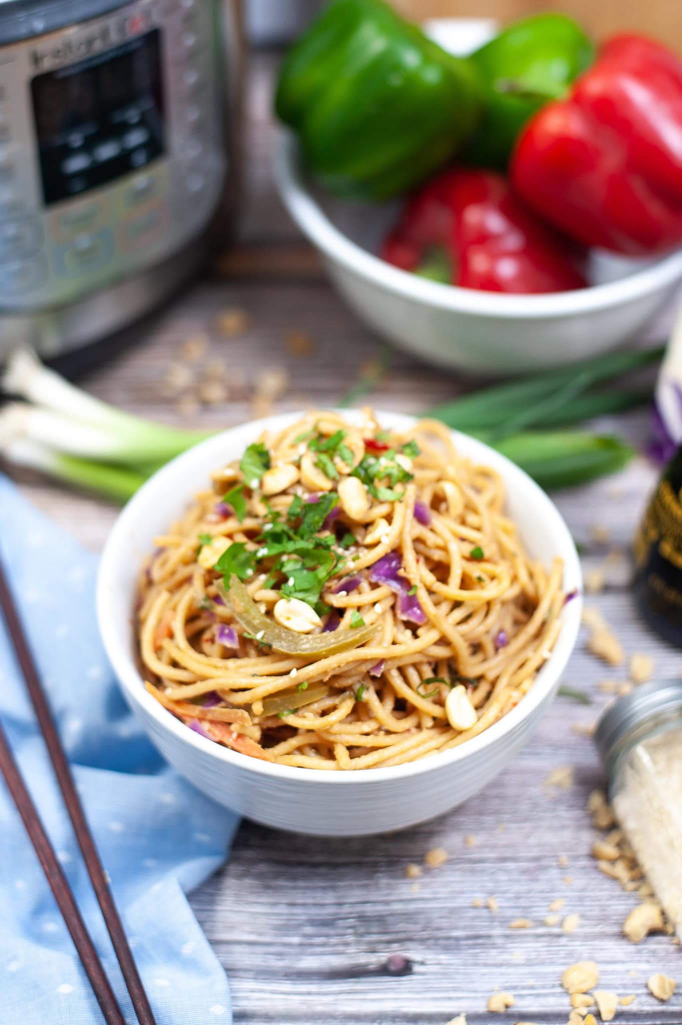 Spicy thai noodles in a bowl, with chopsticks