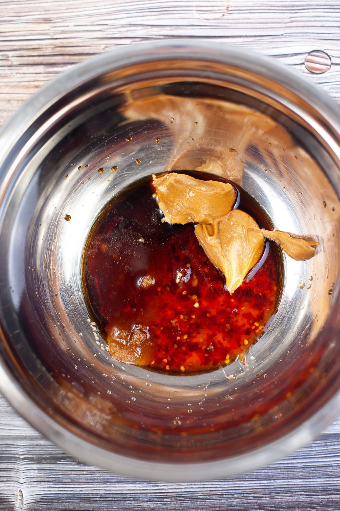 Making the spicy peanut butter sauce: peanut butter, white vinegar, soy sauce, brown sugar, sweet chili sauce