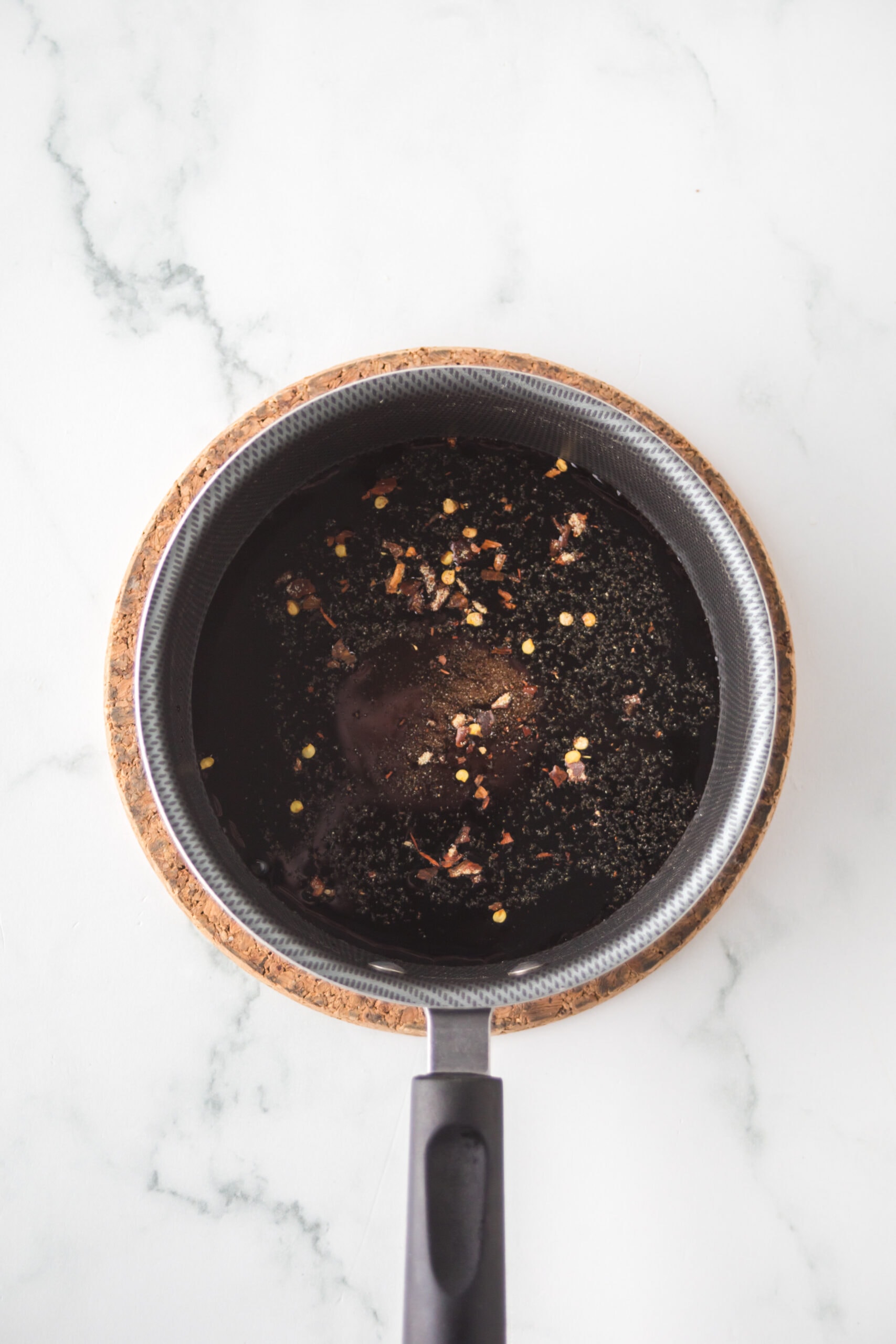 In a saucepan is balsamic vinegar, sugar, soy sauce, red pepper flakes, and garlic powder.