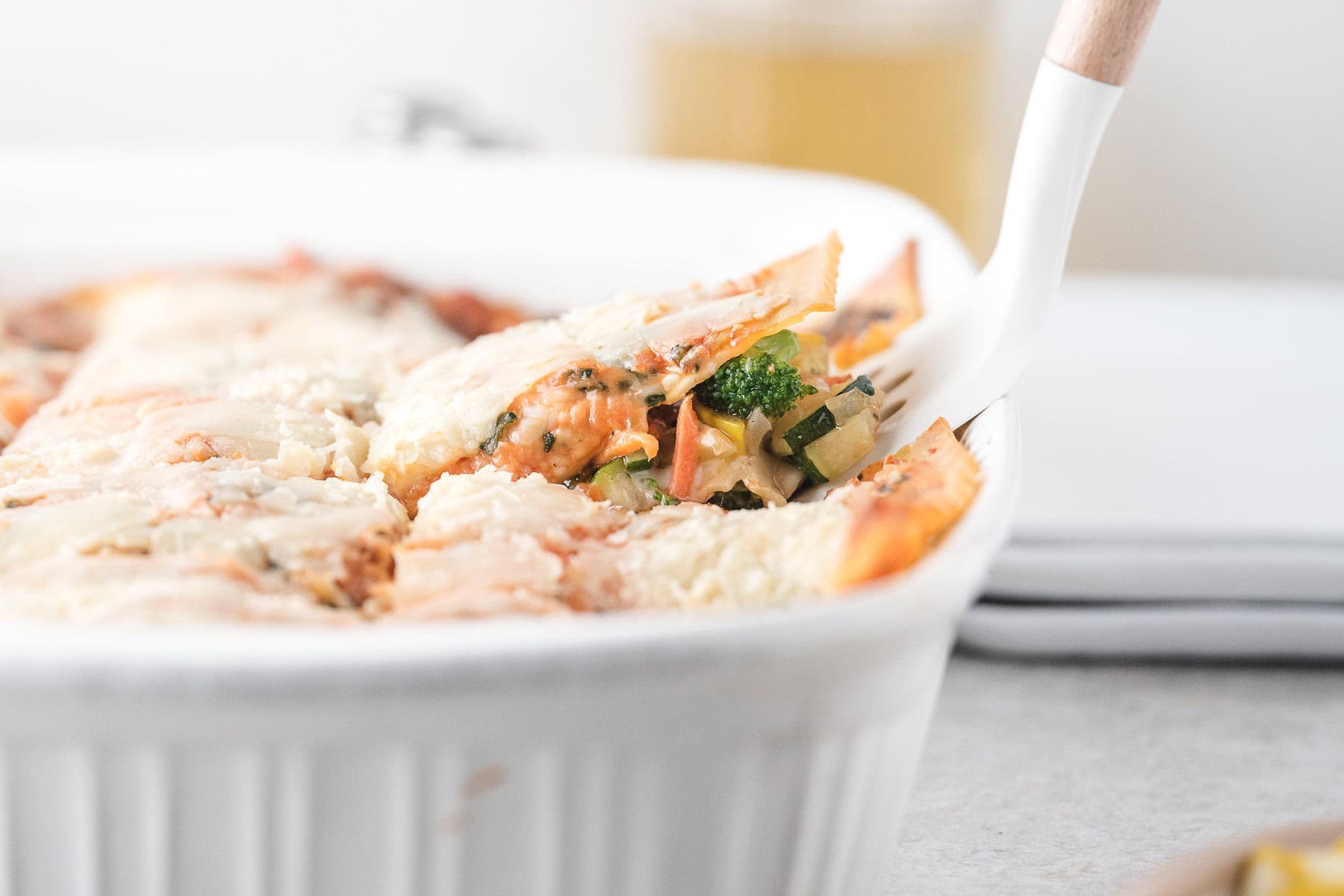 Scooping up the veggie lasagna to serve