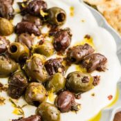 Whipped Feta dip with olives on a white platter