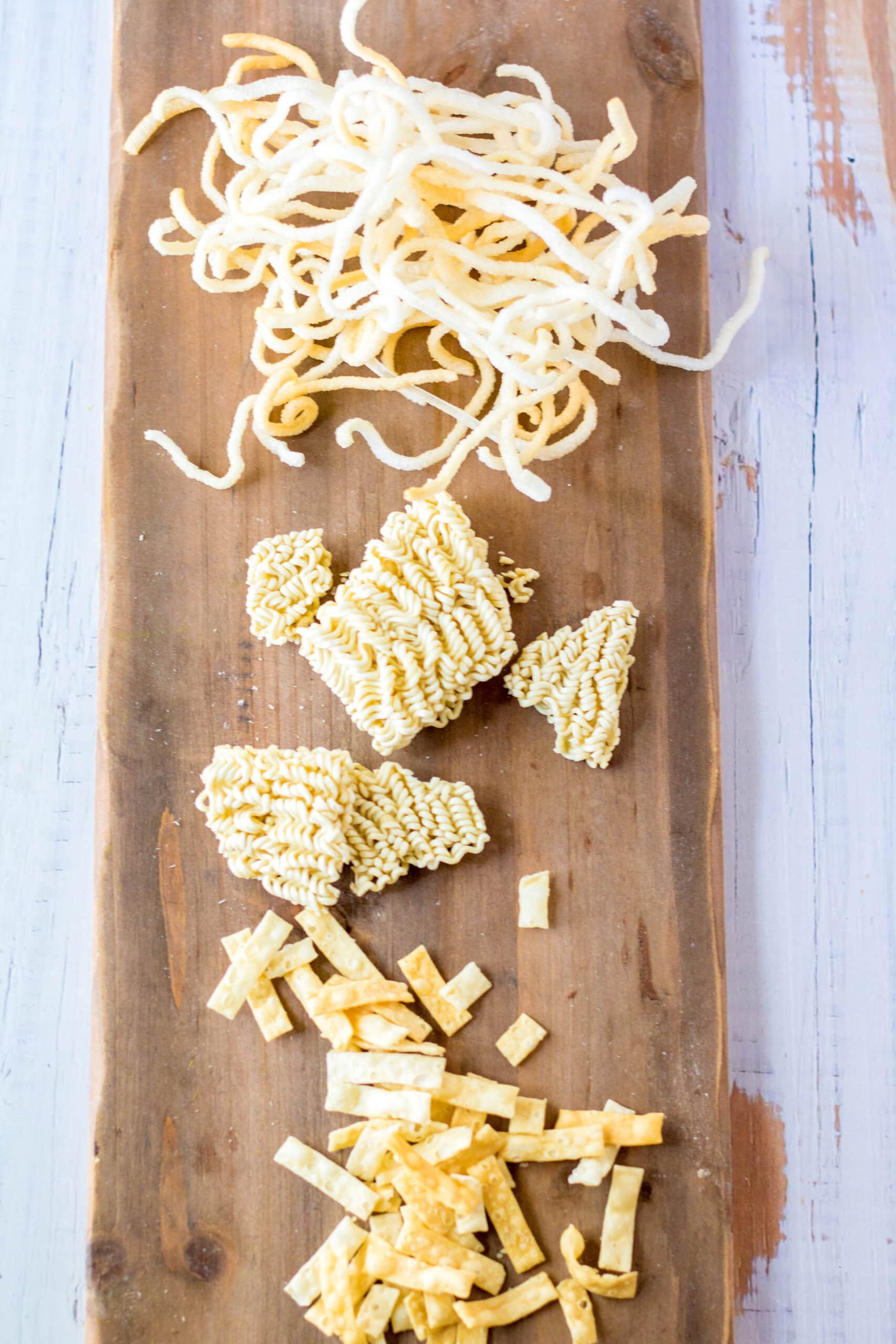 Creating the topping for Chinese salad: wonton strips and fried rice noodles