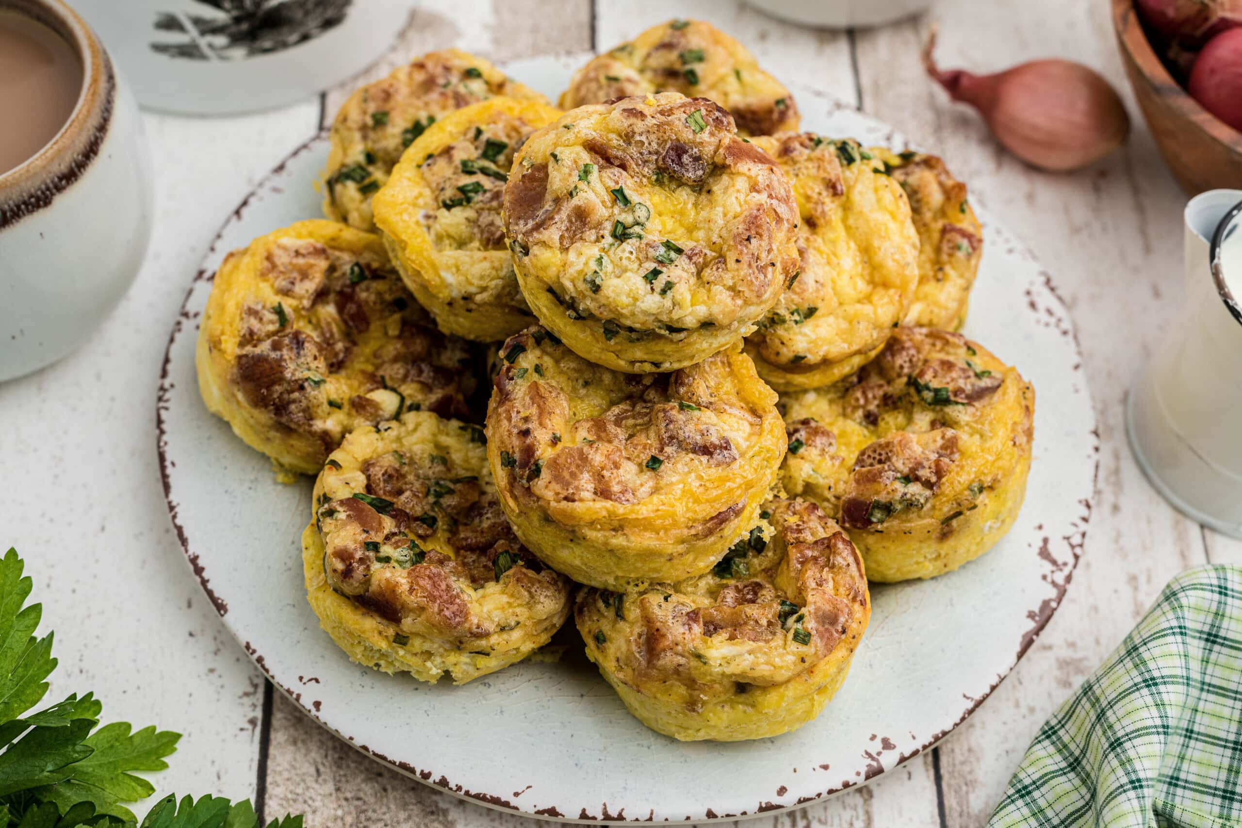 A plate of breakfast muffins piled up.