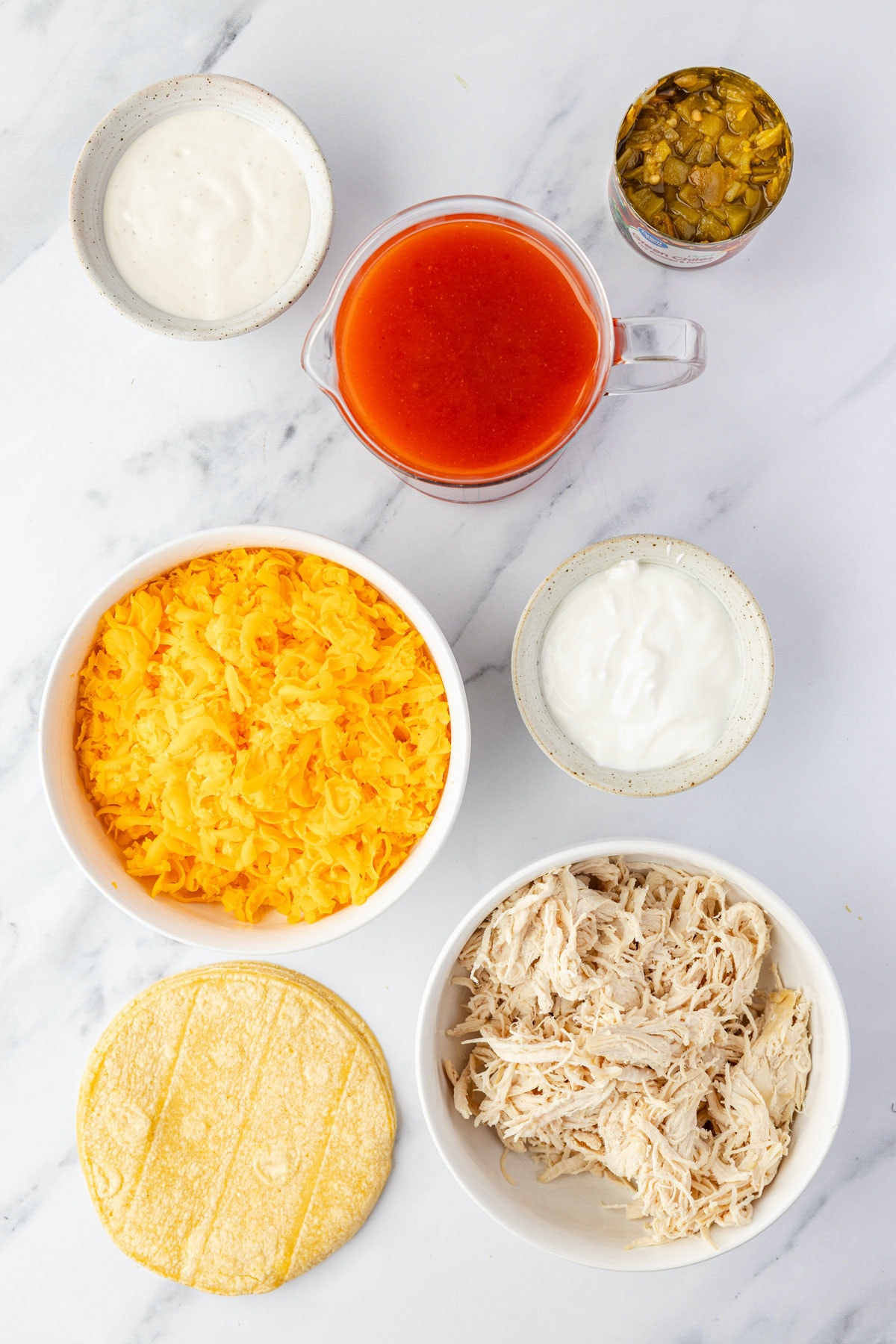 Ingredient list: shredded chicken, corn tortillas, diced chilis, hot sauce, cheddar cheese, sour cream