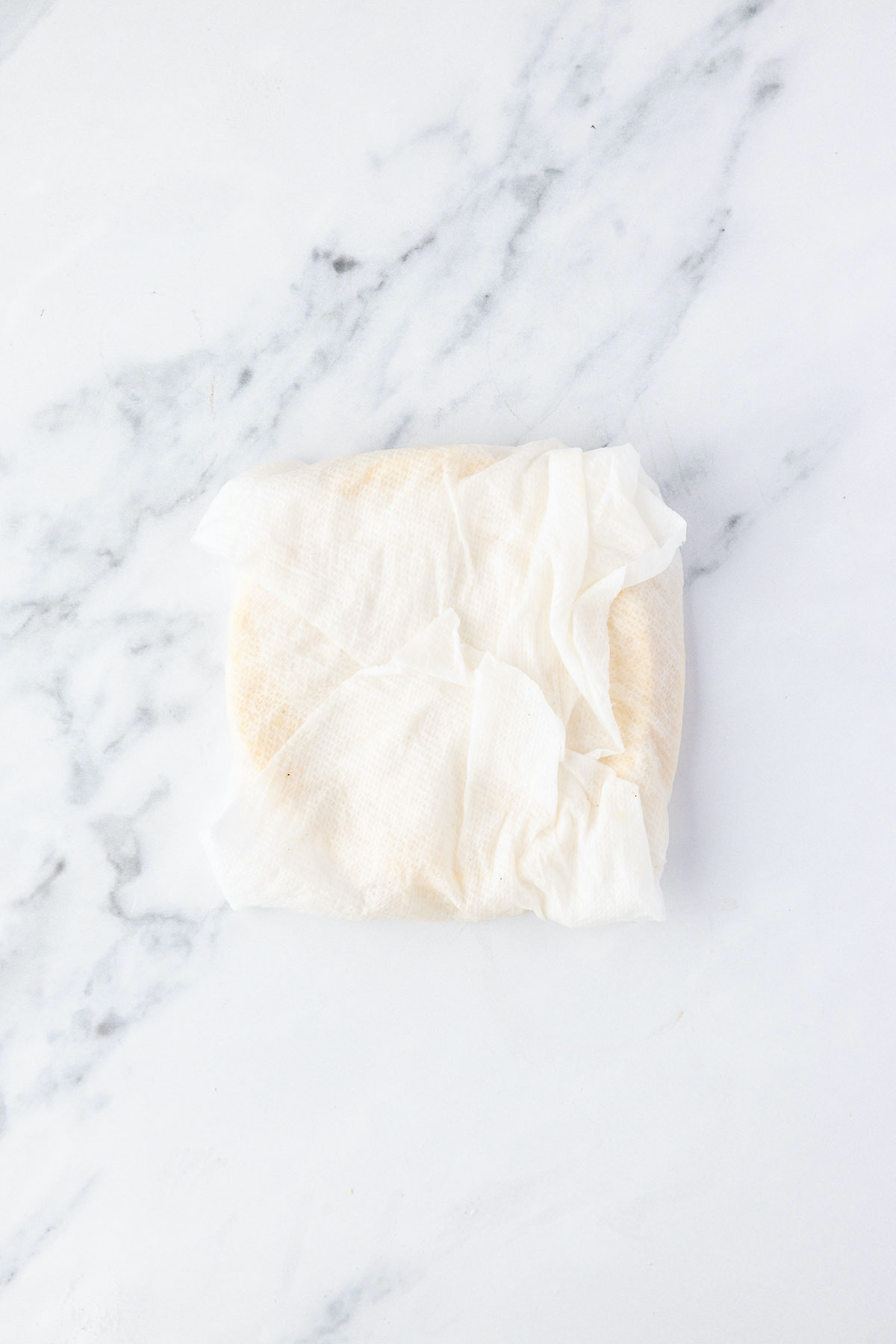 Damp paper towel wrapped around corn tortillas, to be placed in a microwave to soften
