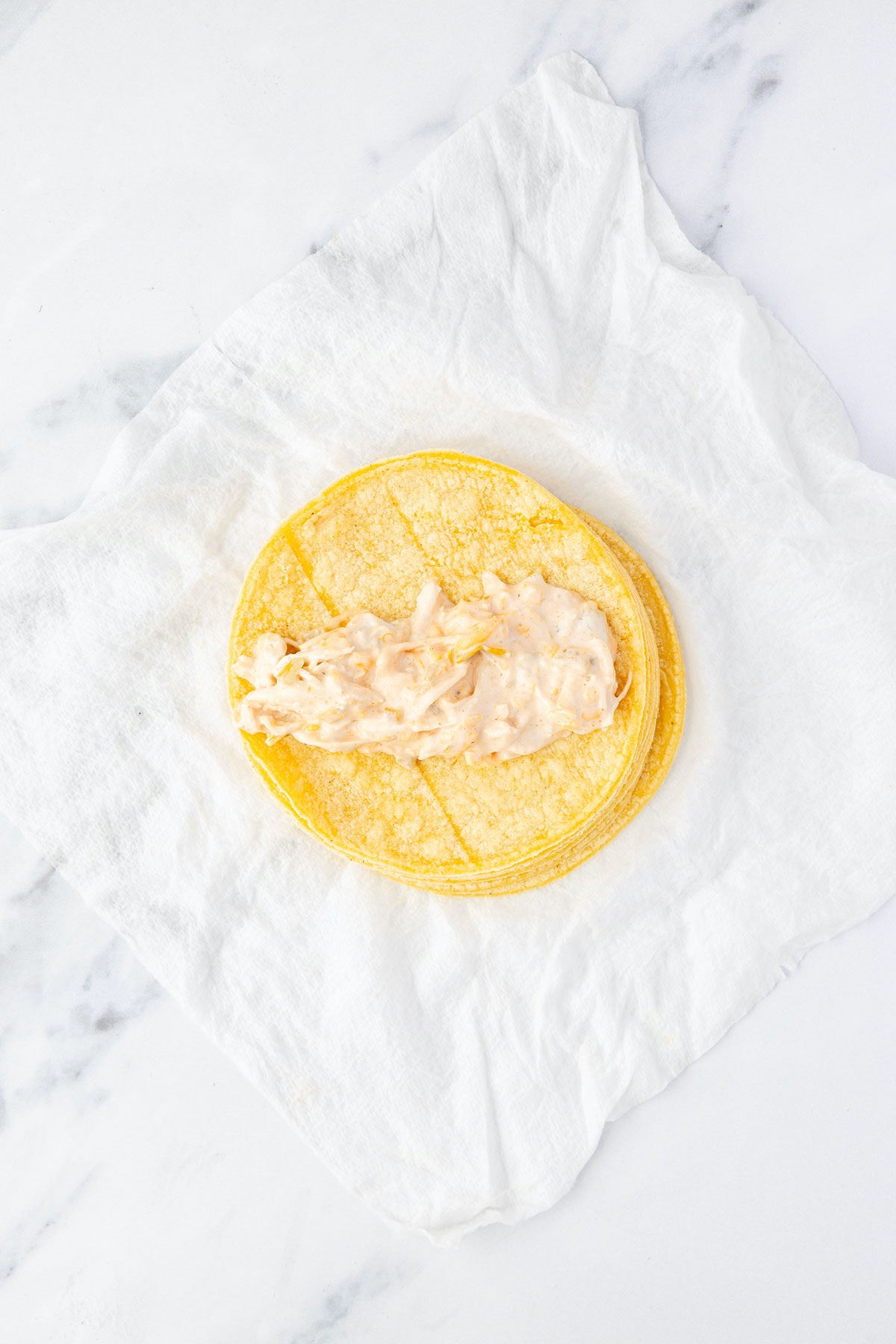 Chicken mixture on top of a tortilla, ready to be wrapped up