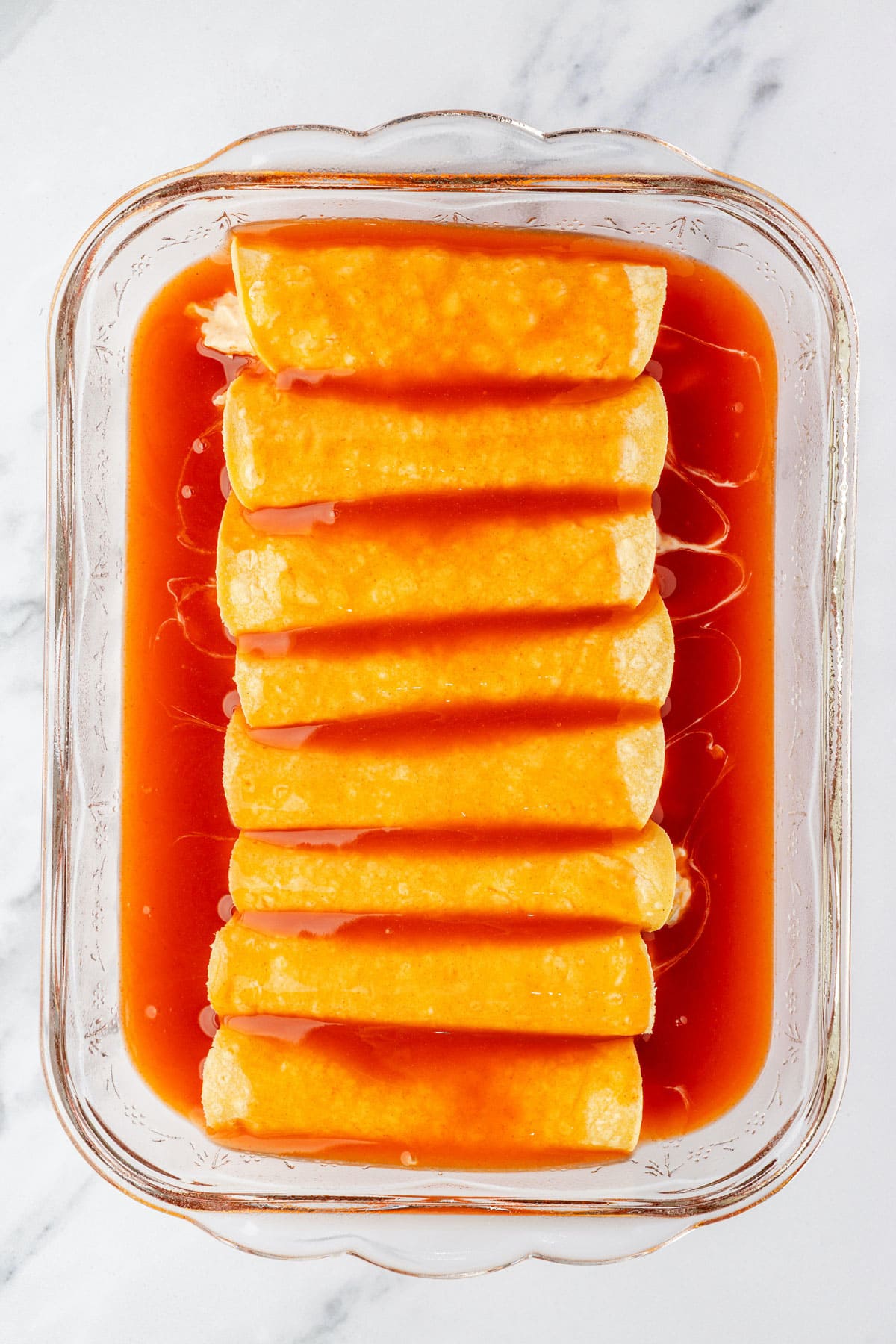 Each tortilla is filled with chicken mixture, rolled up and placed seam side down in baking pan