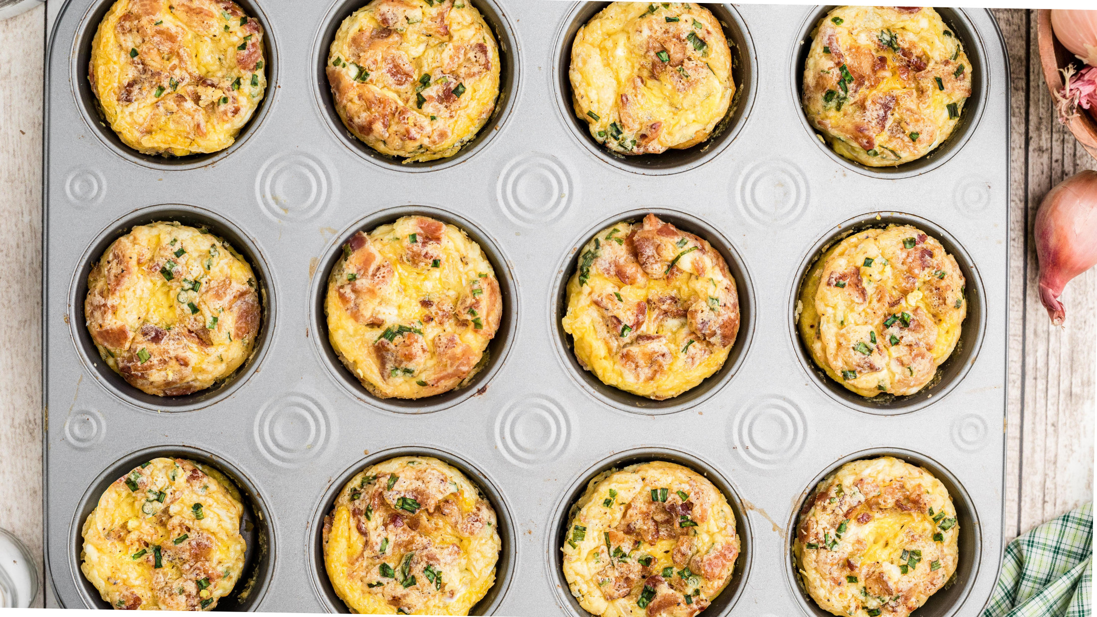 Breakfast muffins in a muffin tin, just baked and cooling
