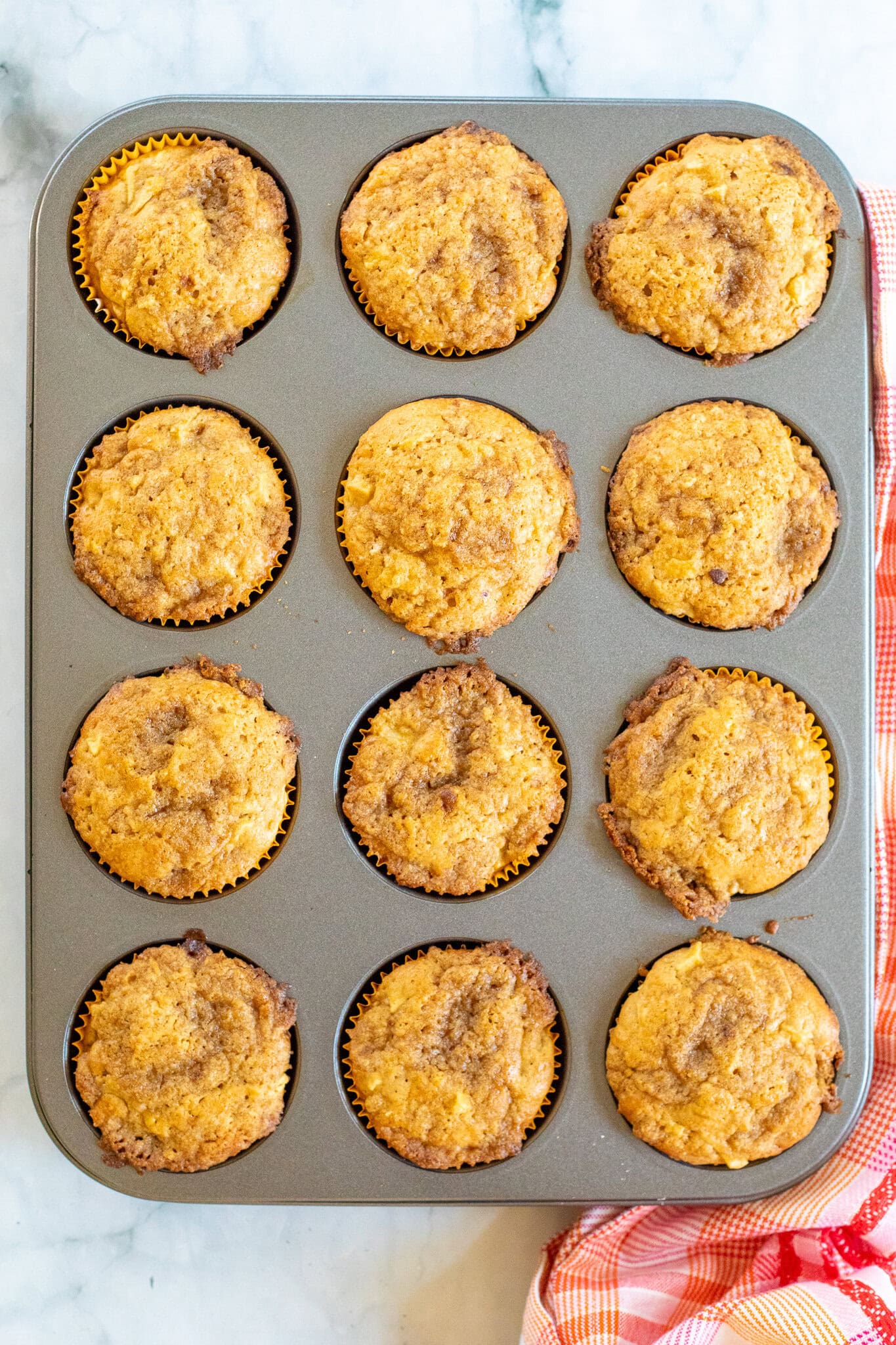 Caramel Apple Muffins in a muffin pan cooling