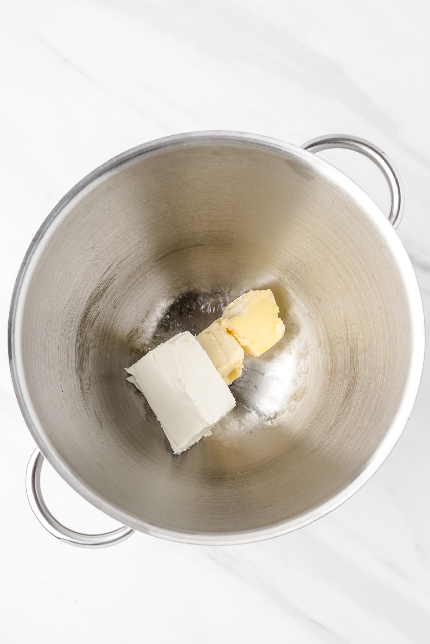 Cream cheese, butter placed in a mixing bowl