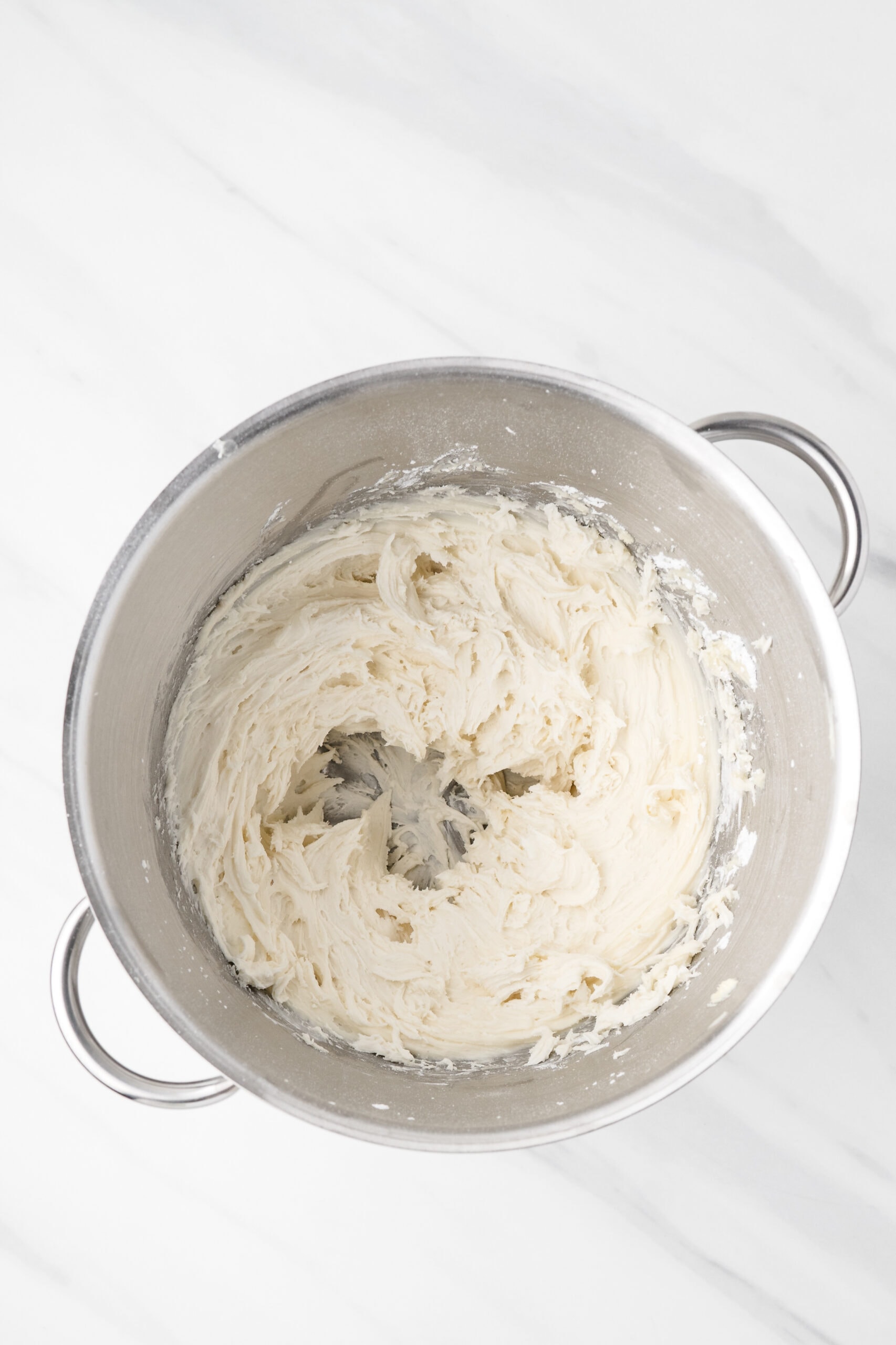 Mixing bowl with cream cheese and butter being whipped up