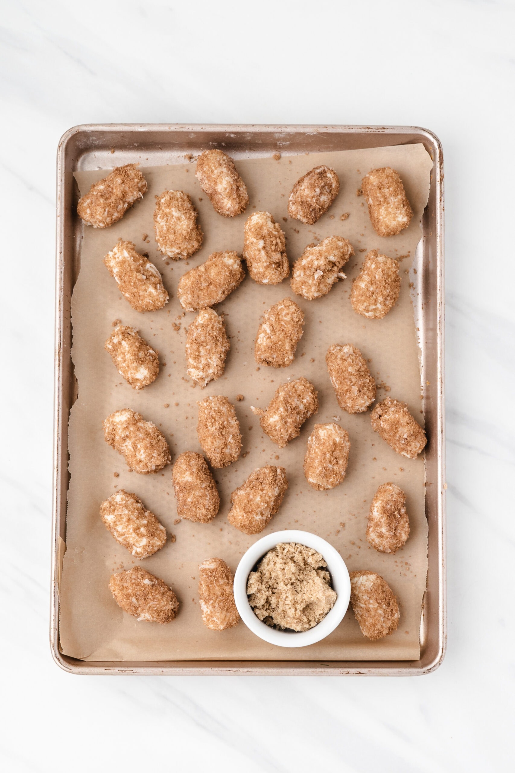 Irish potato candy rolled in brown sugar and cinnamon and placed on a baking sheet