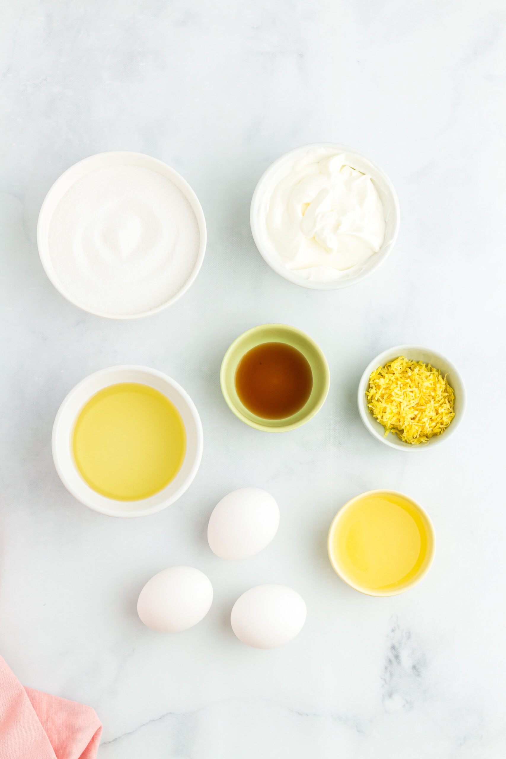 Lemon poppy seed cake ingredients: flour, eggs, lemon zest, lemon juice, vanilla extract, sour cream, flour