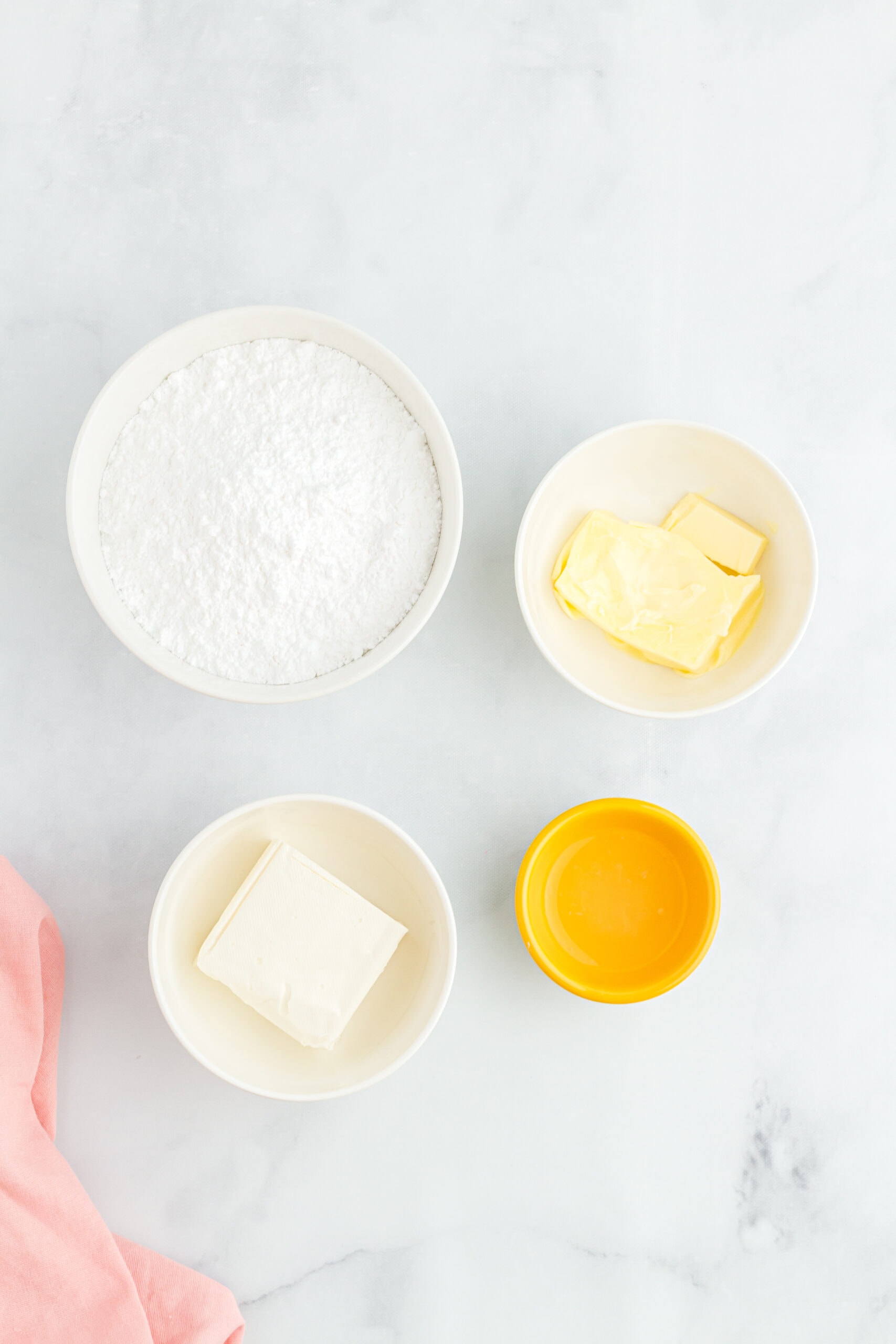 ingredients to create the frosting: cream cheese, powdered sugar, lemon juice and butter