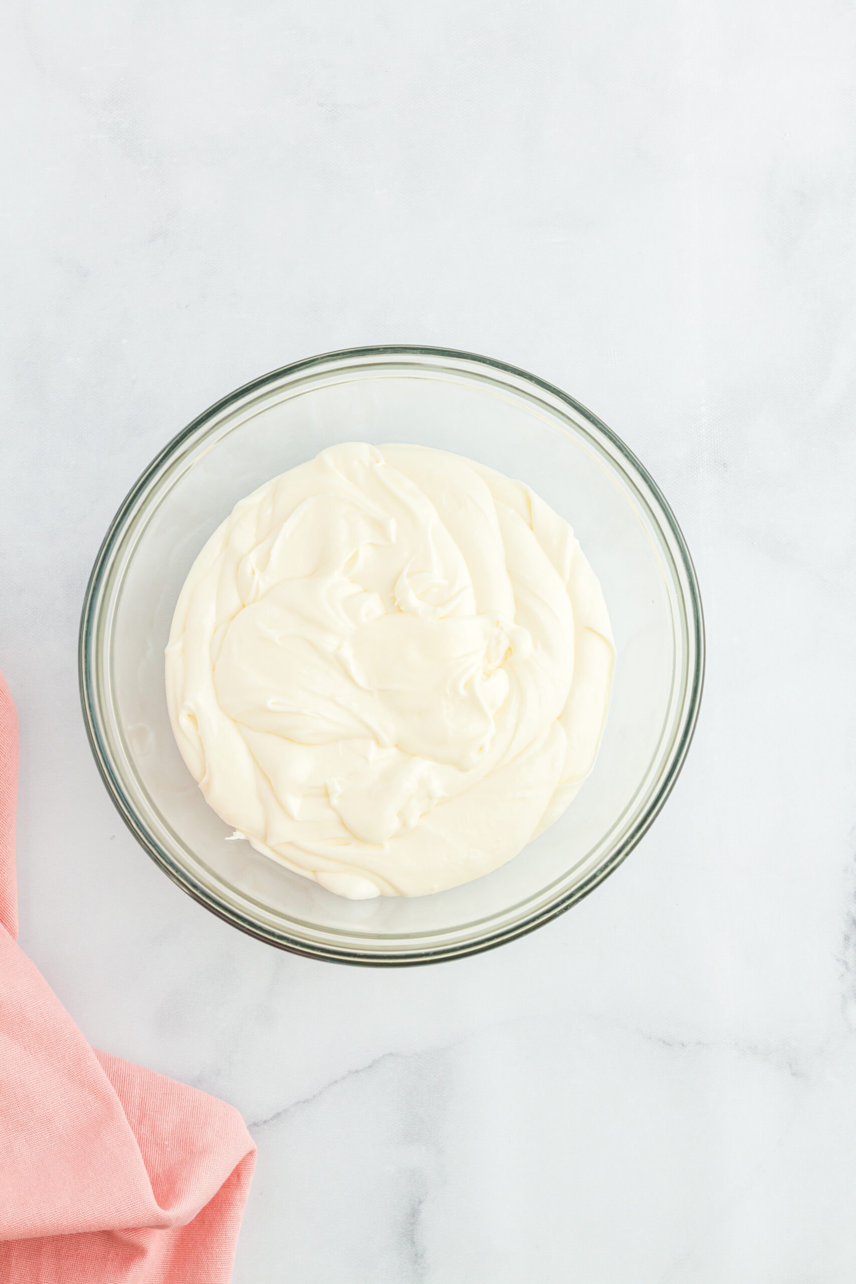 Cream cheese frosting is made up in a mixing bowl