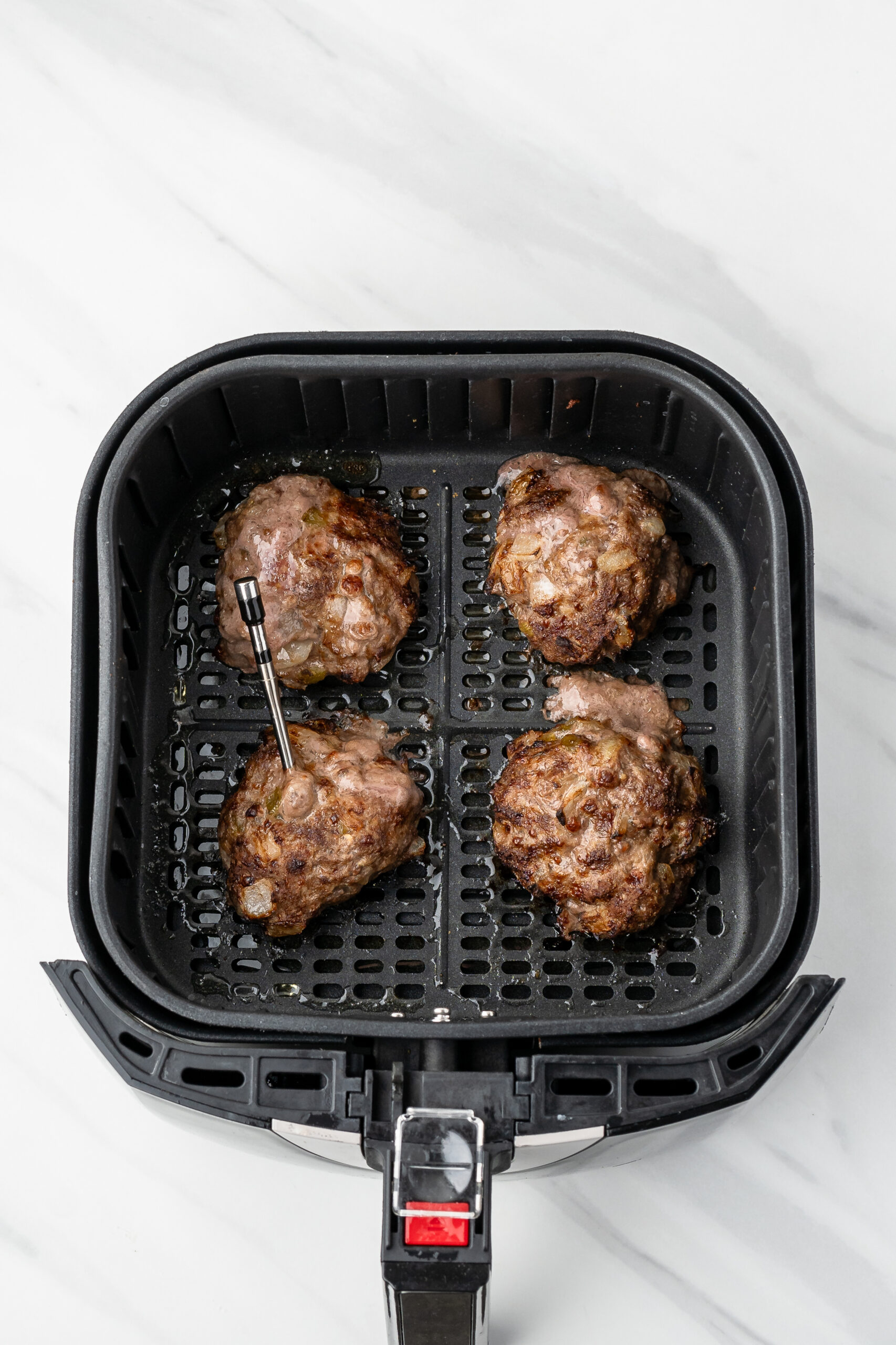Four burgers cooked in the air fryer