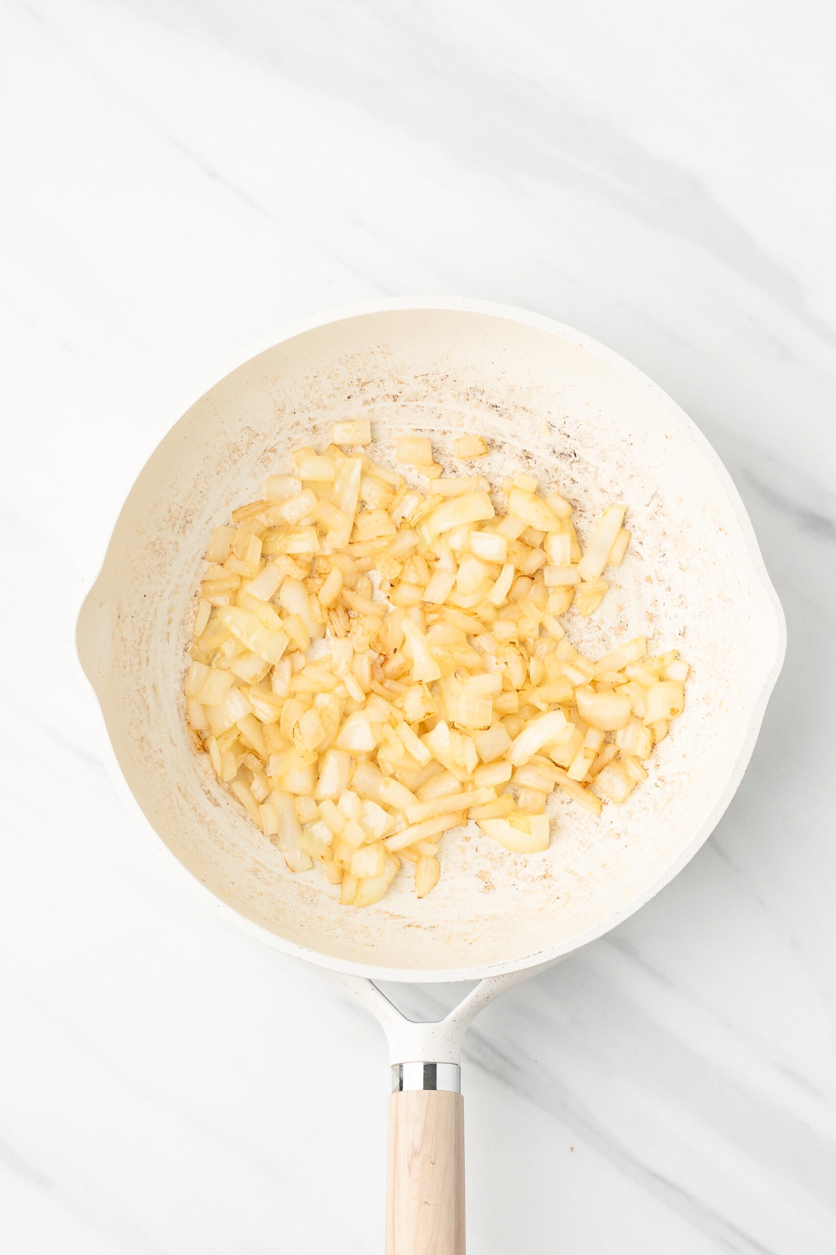 Diced onion in a skillet with butter