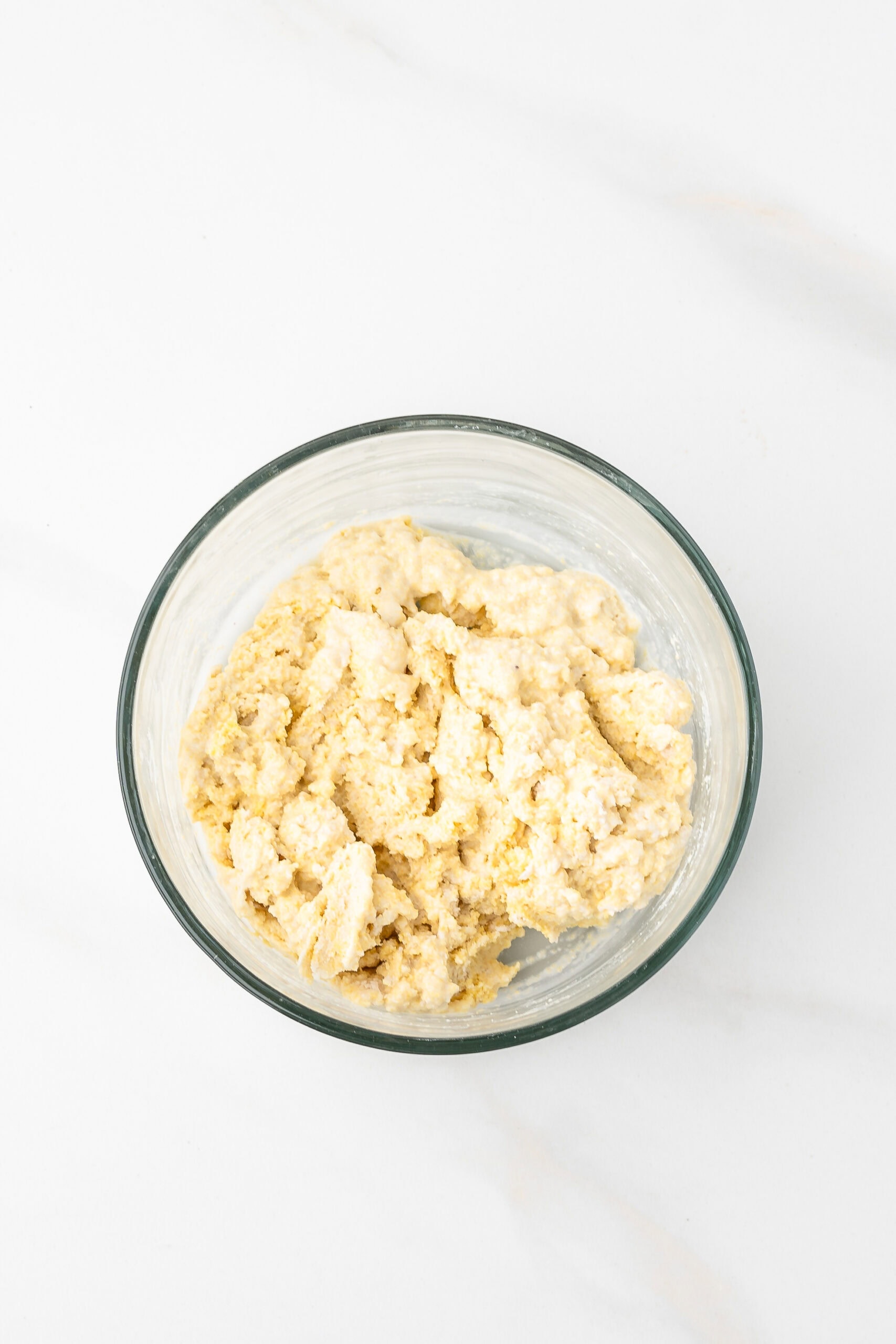 Bisquick, cornmeal, and milk together in a mixing bowl made a dough to create dumplings for the chicken chili