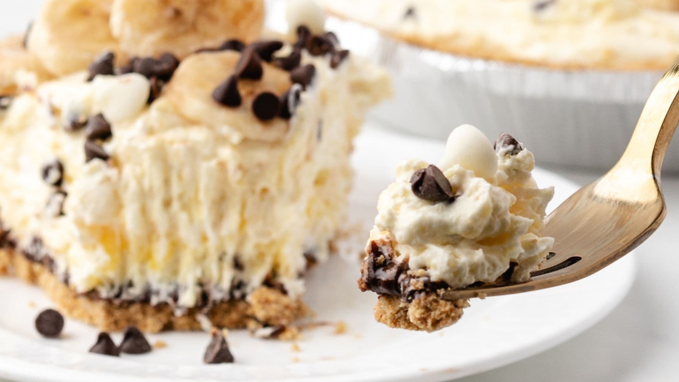 A fork holding a bit of the banana cream pie