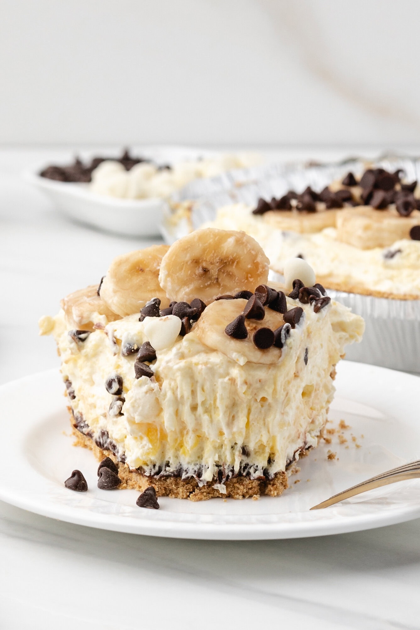 Banana Cream Pie slice, with a fork taking a piece out of it