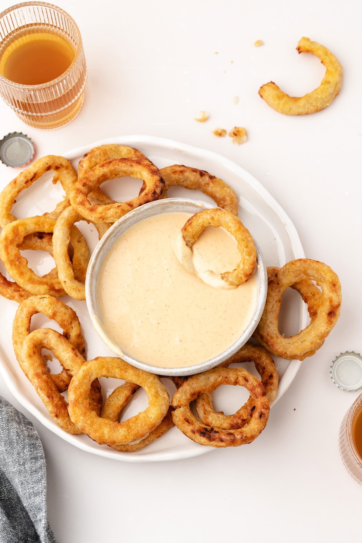 onion rings with onion ring dipping sauce and a glass of apple juice