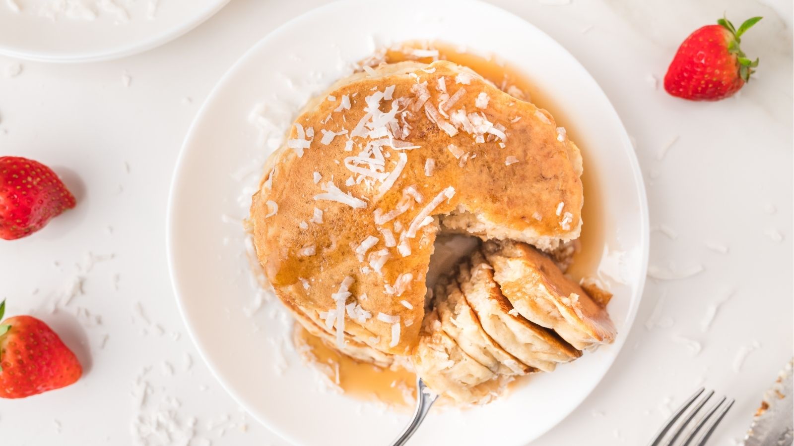 coconut pancakes stacked on plate