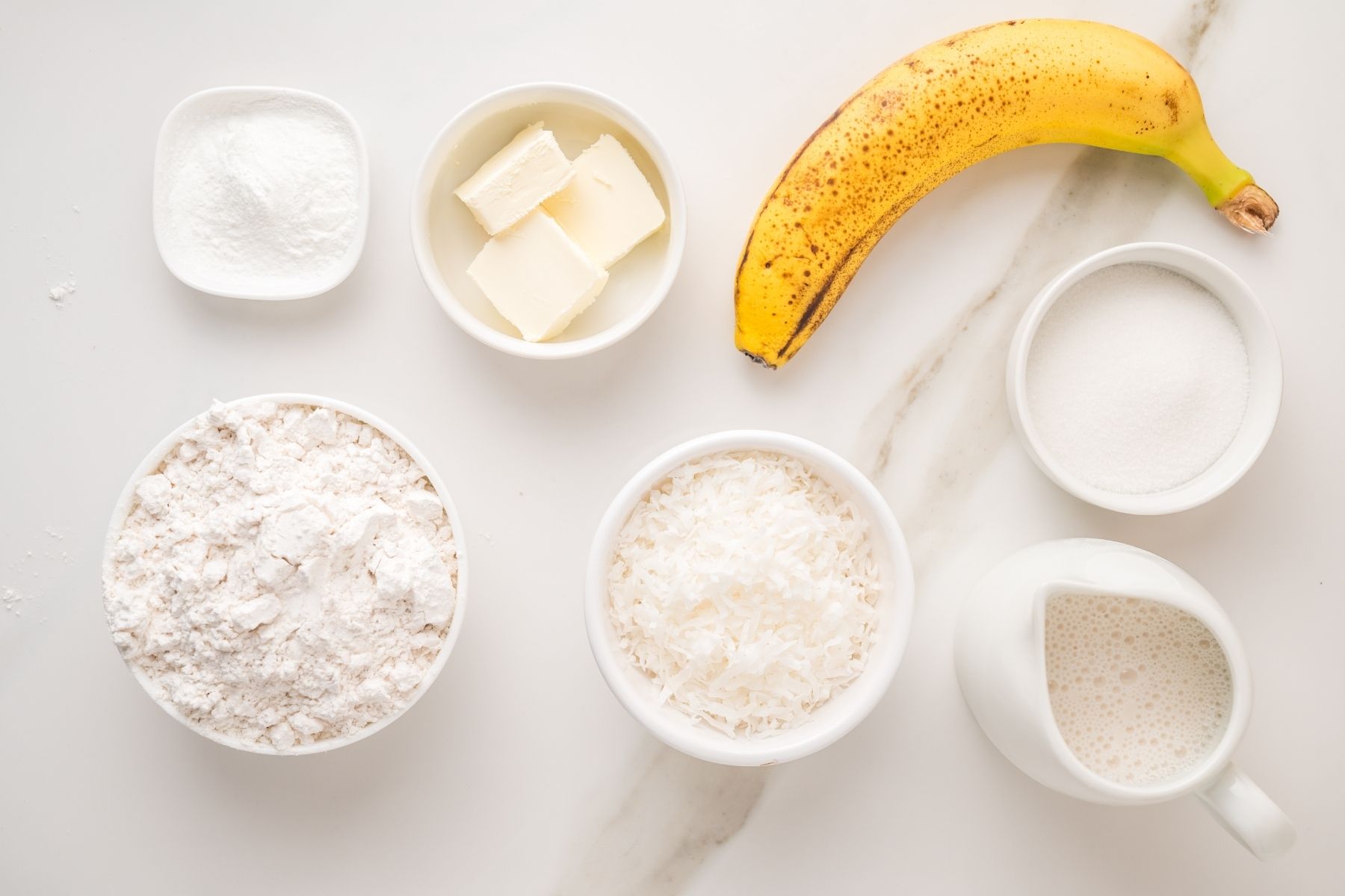 Coconut pancake ingredients with flour eggs and shredded coconut