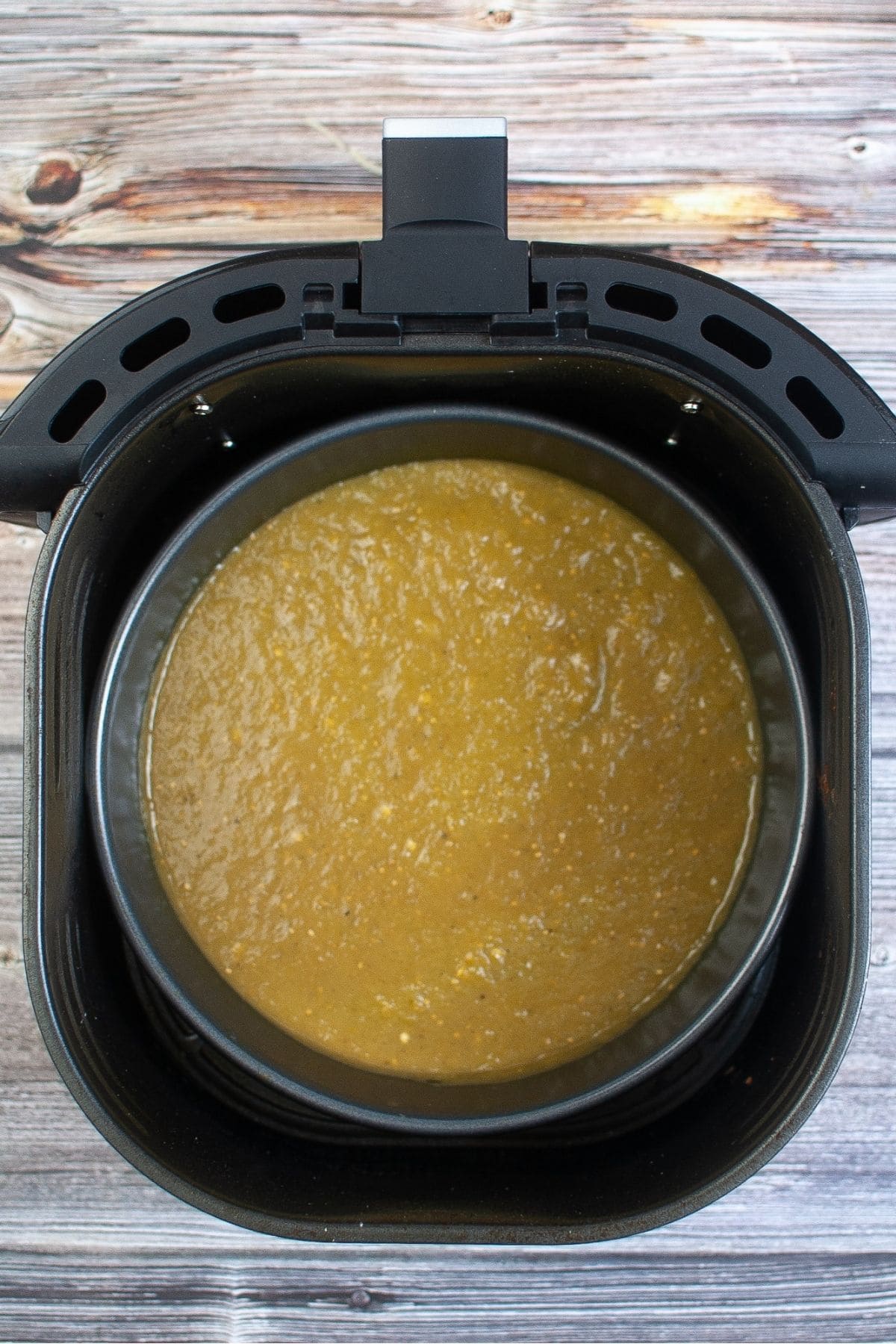 Preparing the air fryer for cooking Green chili chicken enchilada