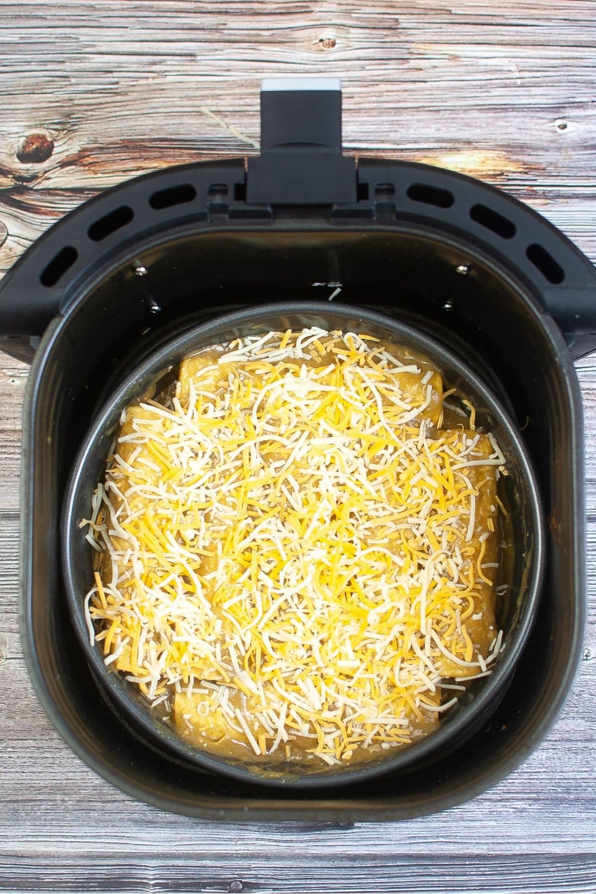 Green chili enchiladas covered with sauce and cheese
