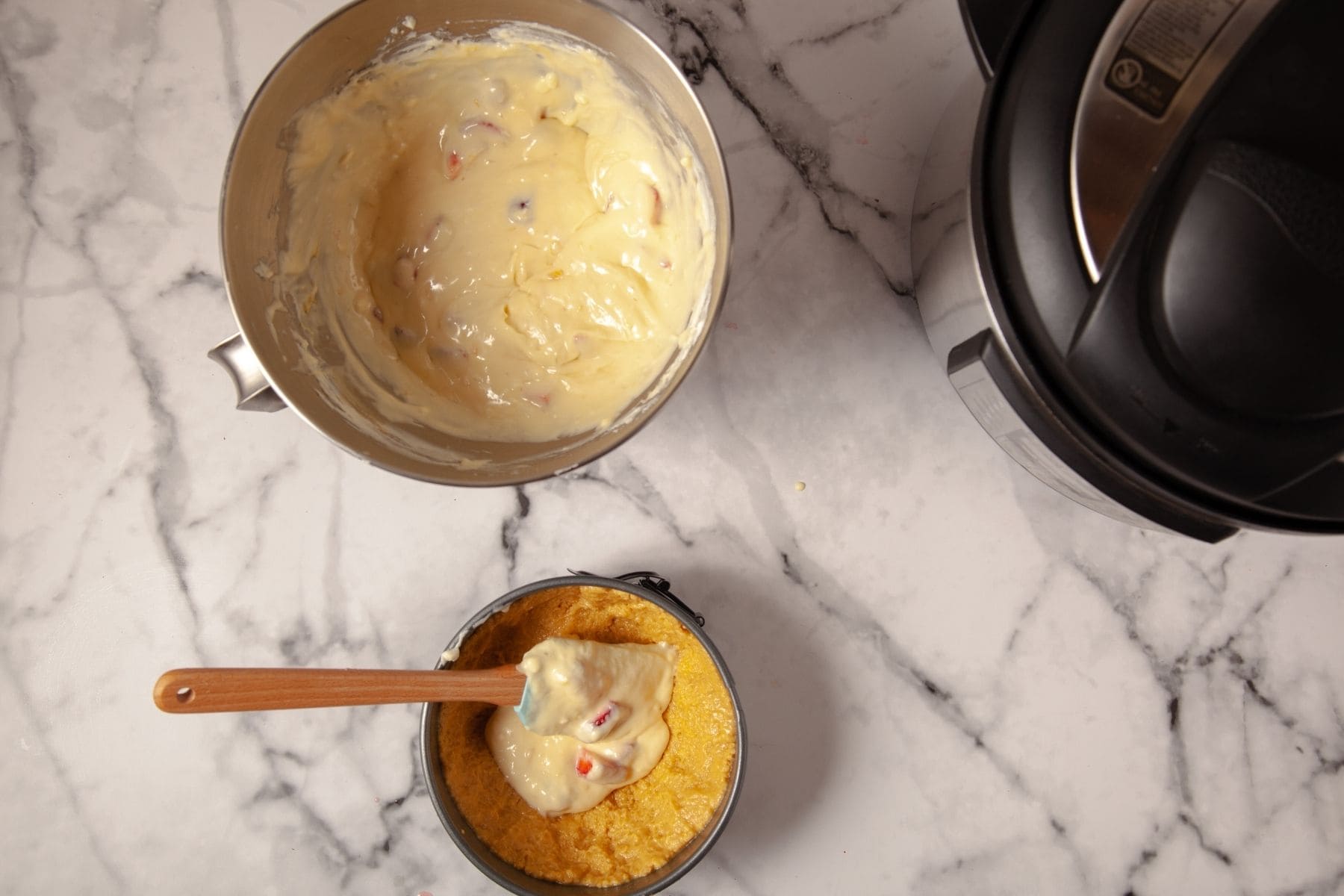 Strawberry cheesecake filling spread over graham cracker crust