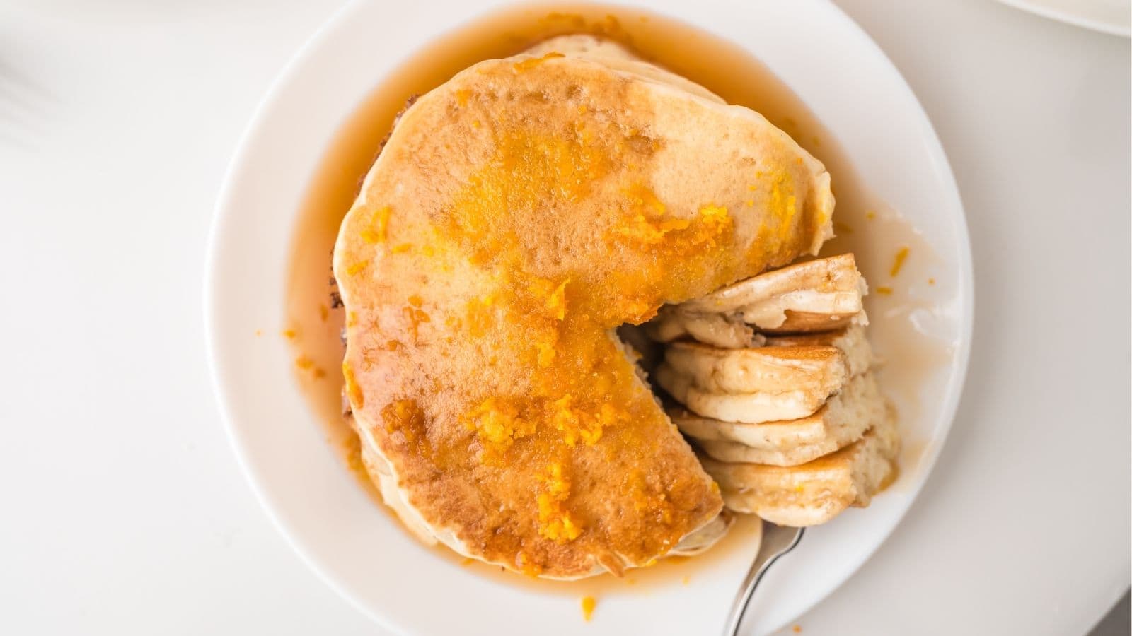 orange pancakes on white plate