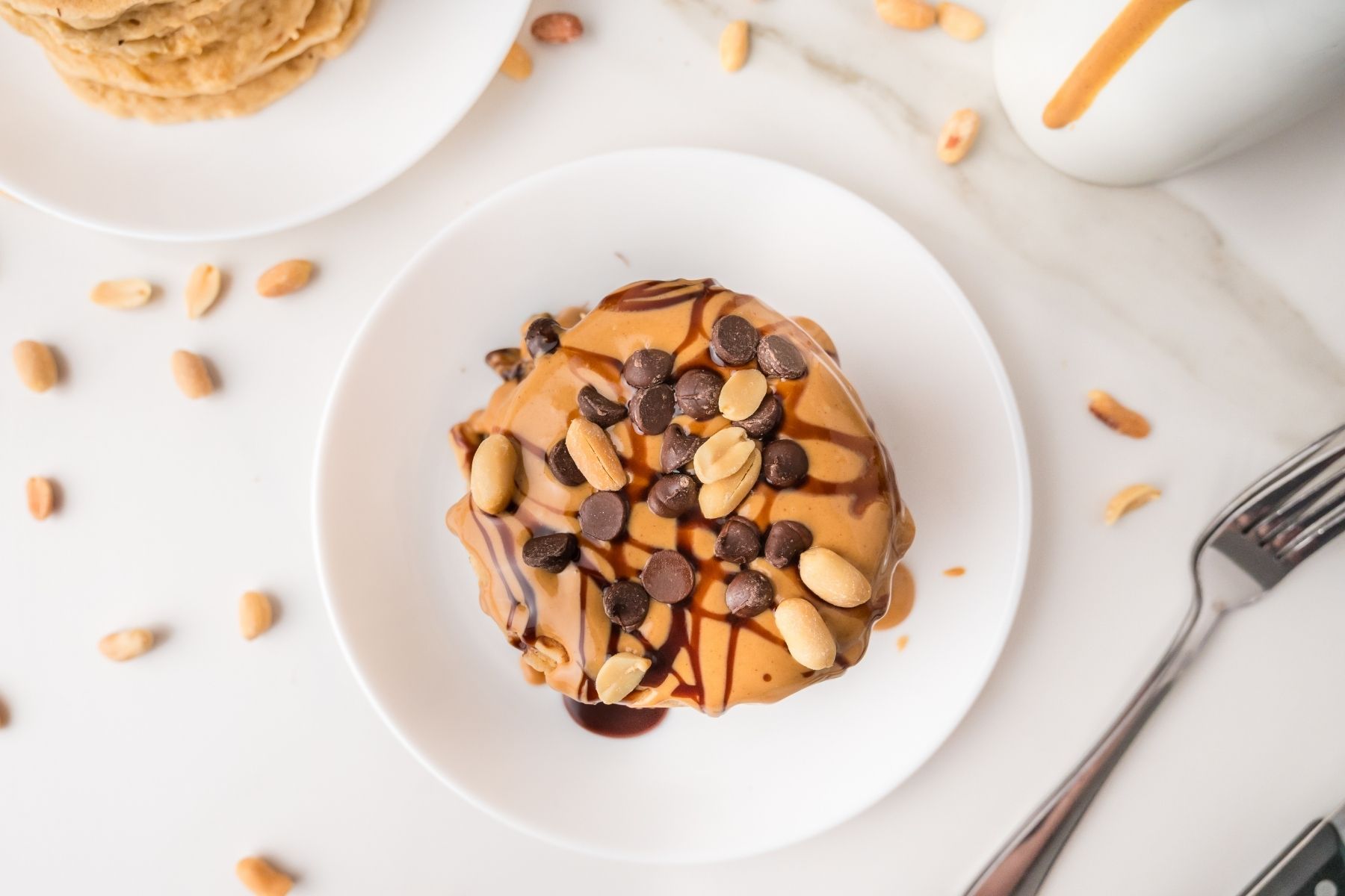 Fluffy peanut butter pancakes stacked on plate