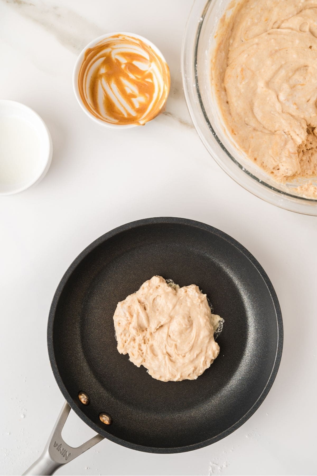 Peanut butter pancakes cooking on hot griddle