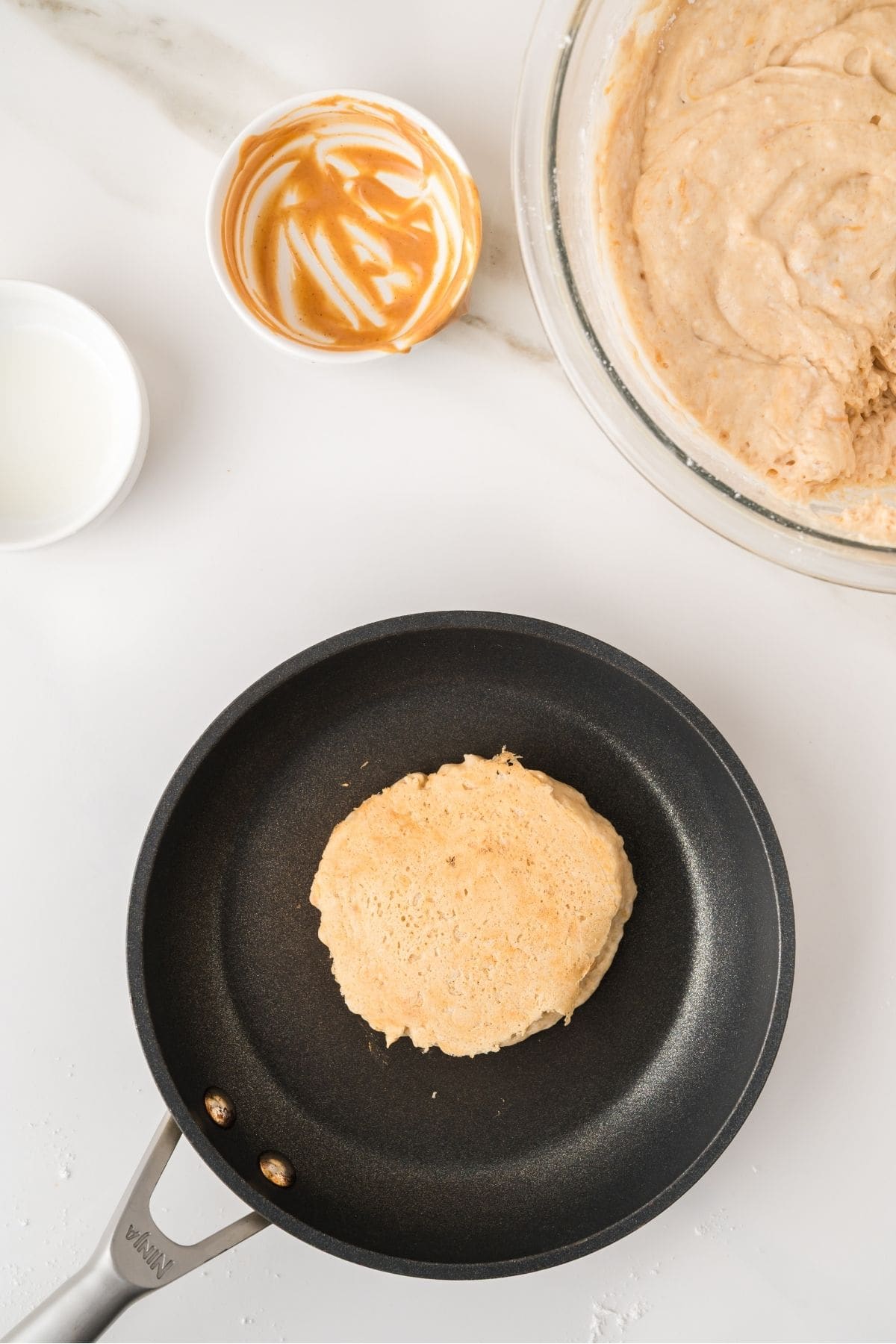 Peanut butter pancakes cooking on hot griddle