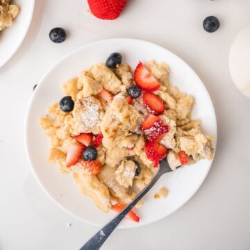 Fluffy scrambled pancakes on white plate