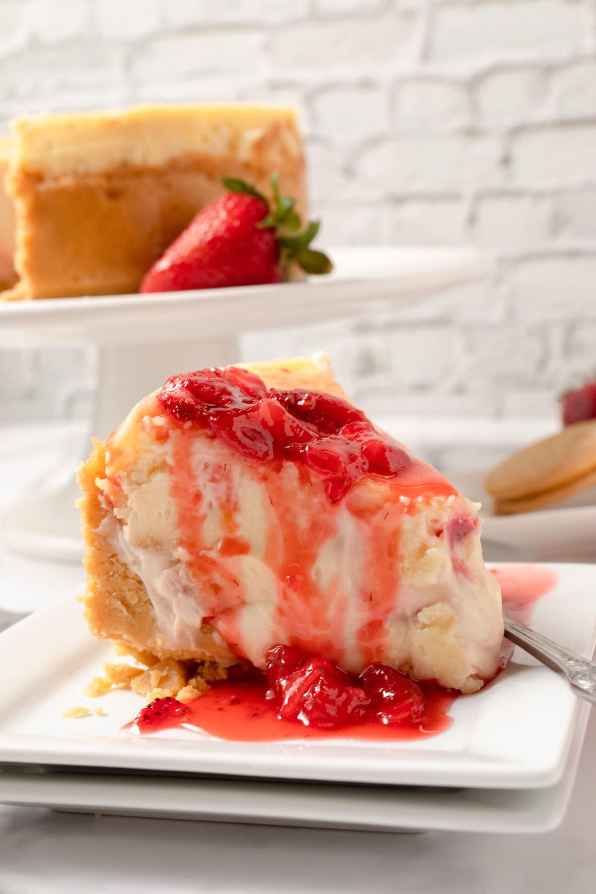 homemade strawberry sauce over a slice of cheesecake
