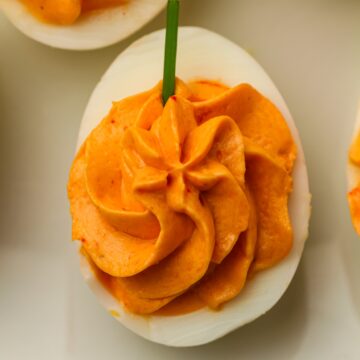 Pumpkin deviled eggs with creamy orange filling